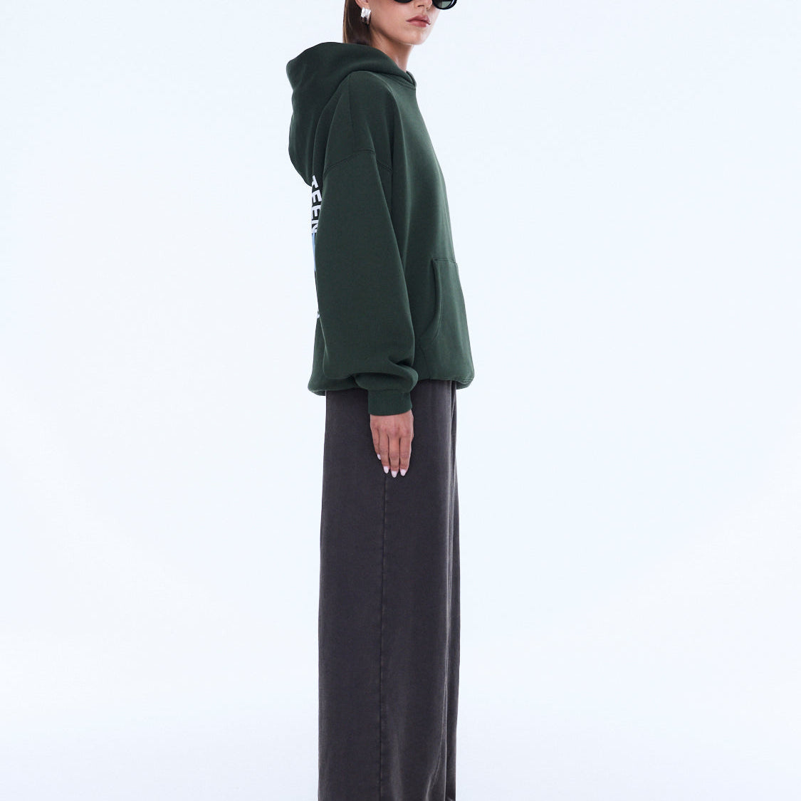 Side profile of moss green Aries Hoodie with oversized fit and hood