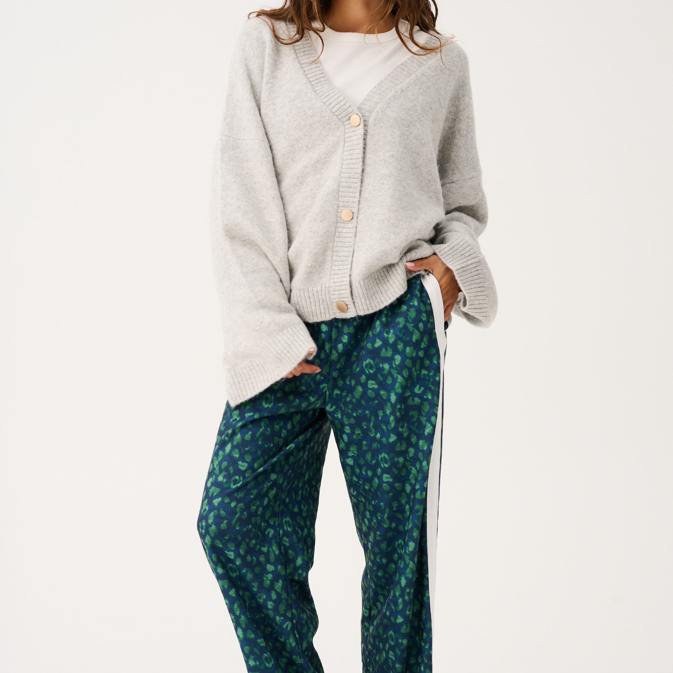Full body view showing oversized fit of grey marle knit cardigan with long sleeves