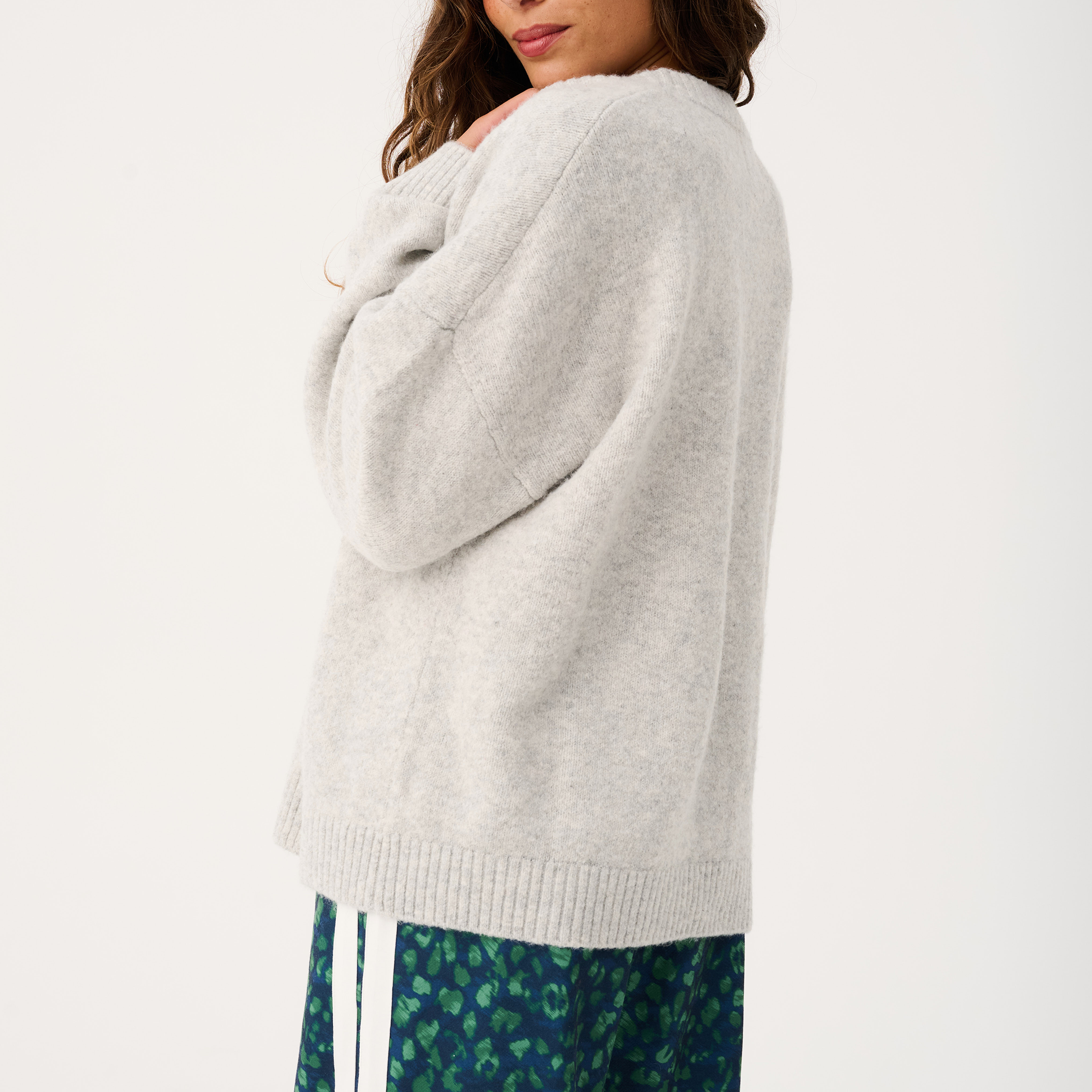 Back view of Adela knit cardigan in grey marle showing relaxed silhouette and ribbed hem
