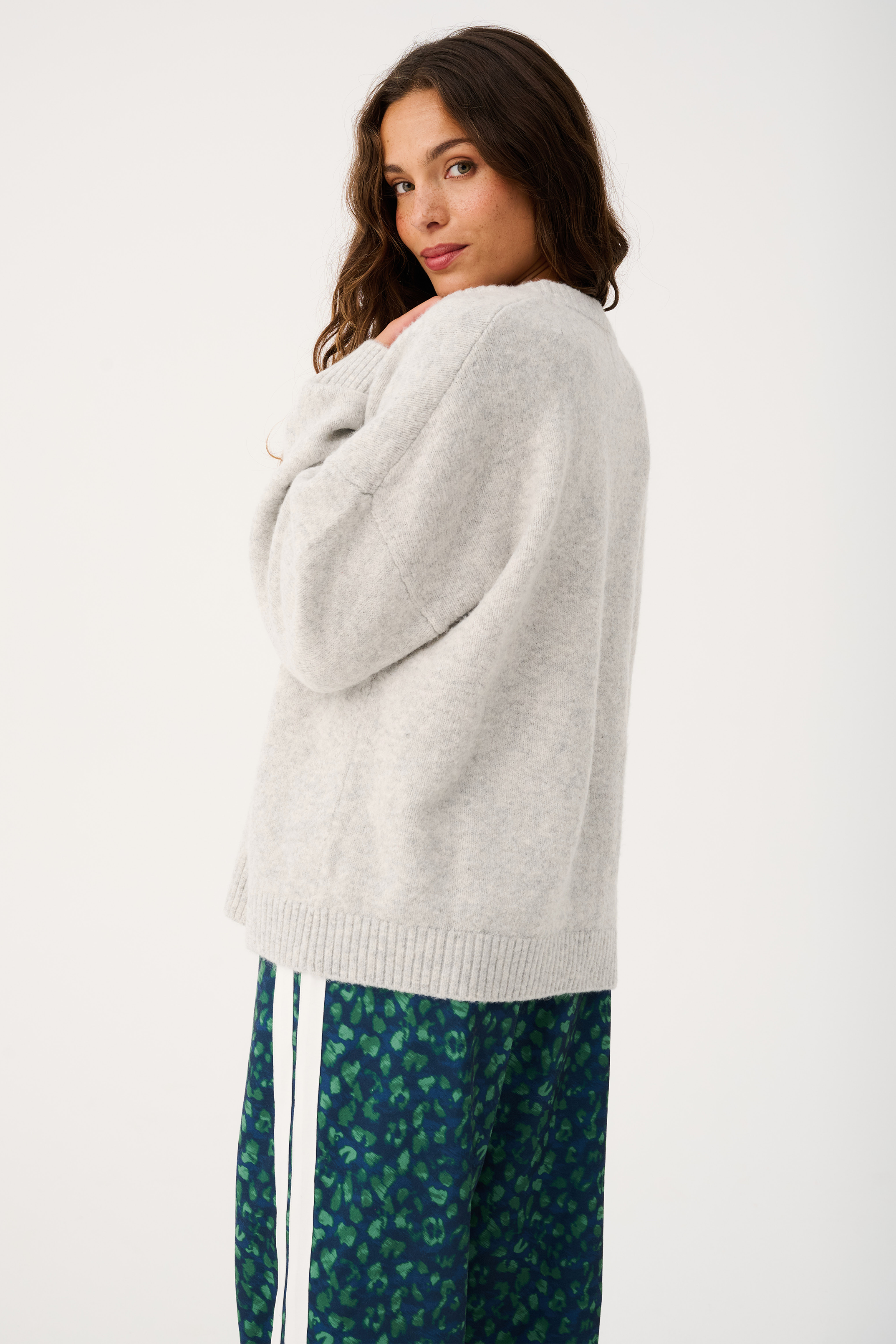Back view of Adela knit cardigan in grey marle showing relaxed silhouette and ribbed hem