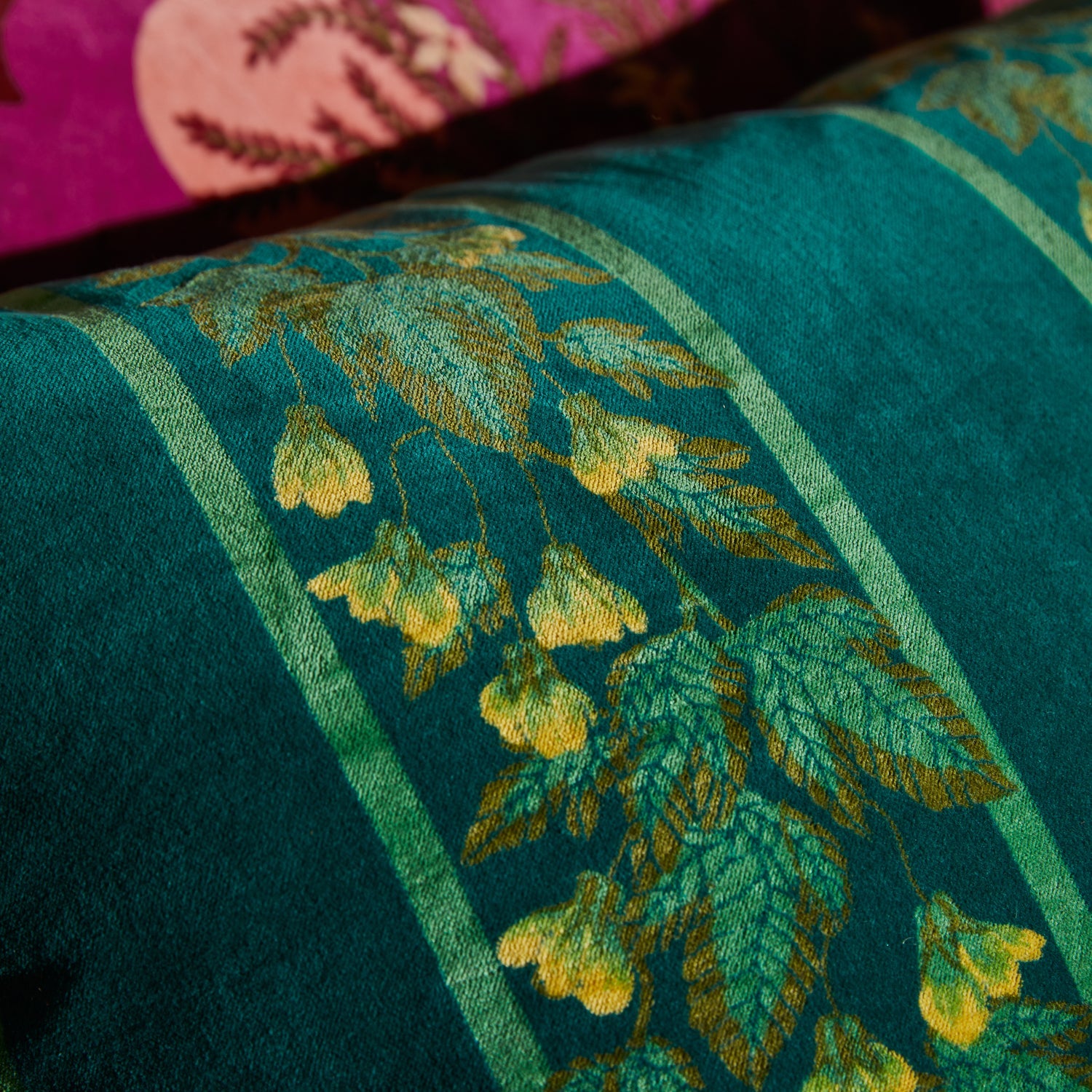 Close-up detail of soft-touch velvet fabric showing botanical leaf and flower pattern on Agata Cushion
