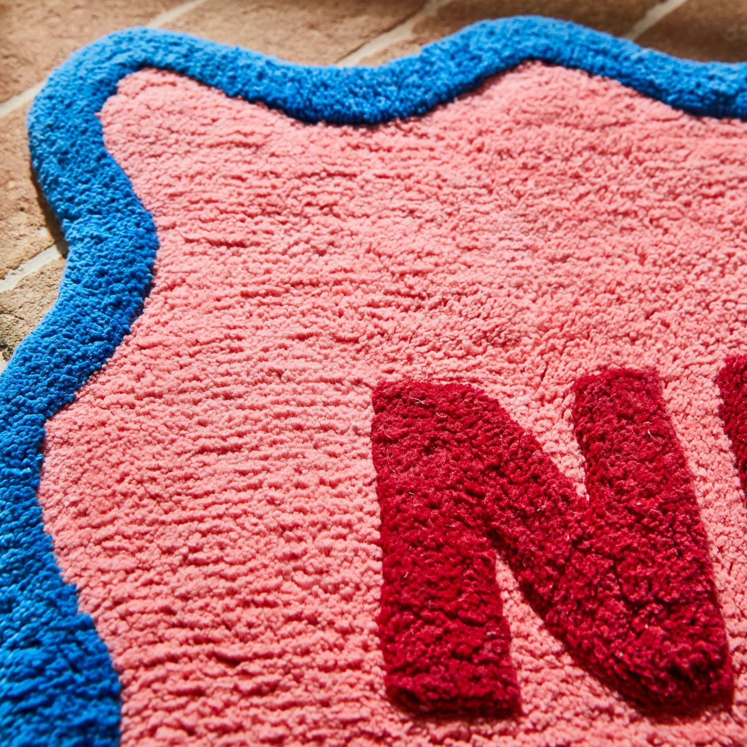 fabric details of Amalie Nudie Bath Mat - Hibiscus by Sage & Clare