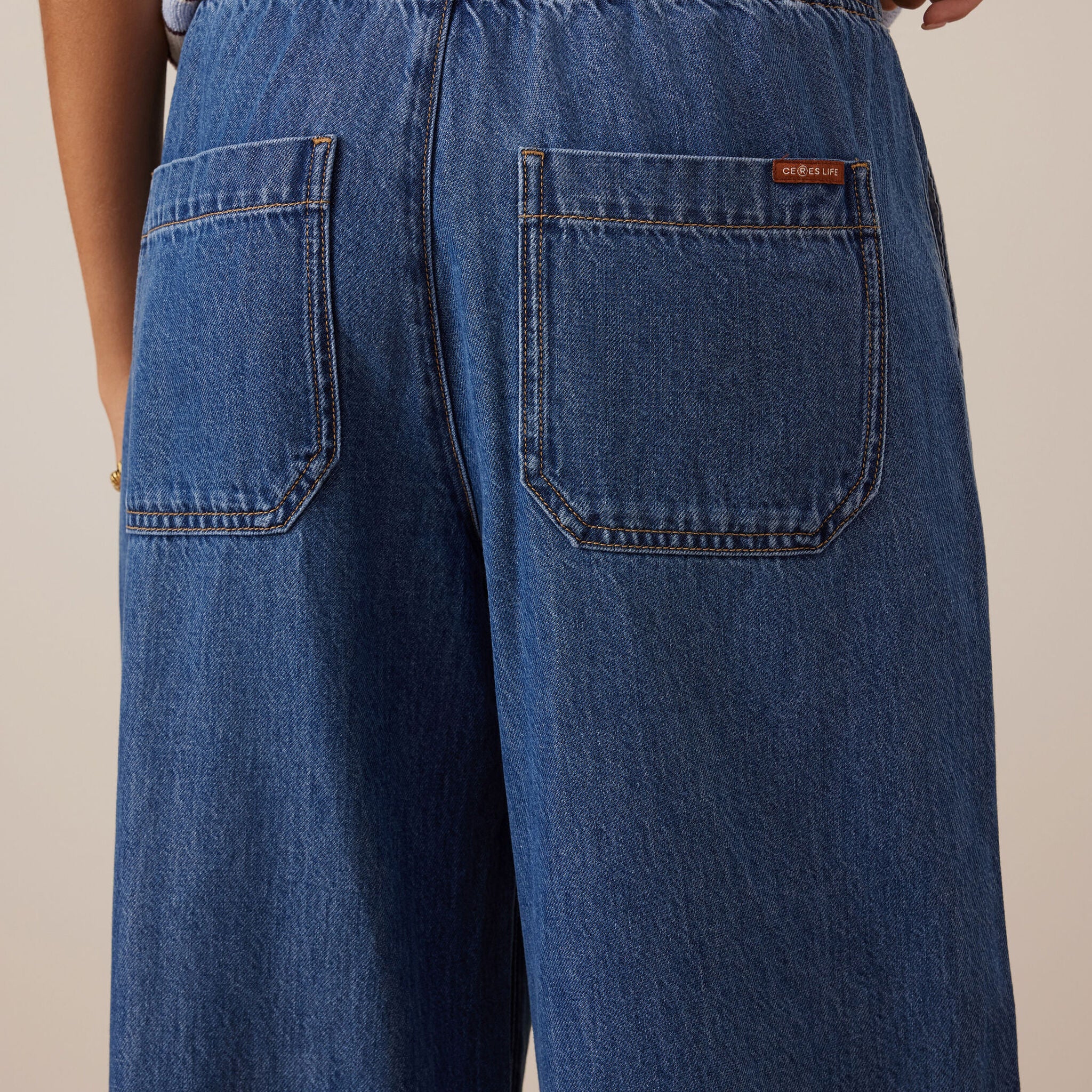 Close-up back view of Andie Wide Leg Drawstring Pant showing denim patch pockets and elastic waistband