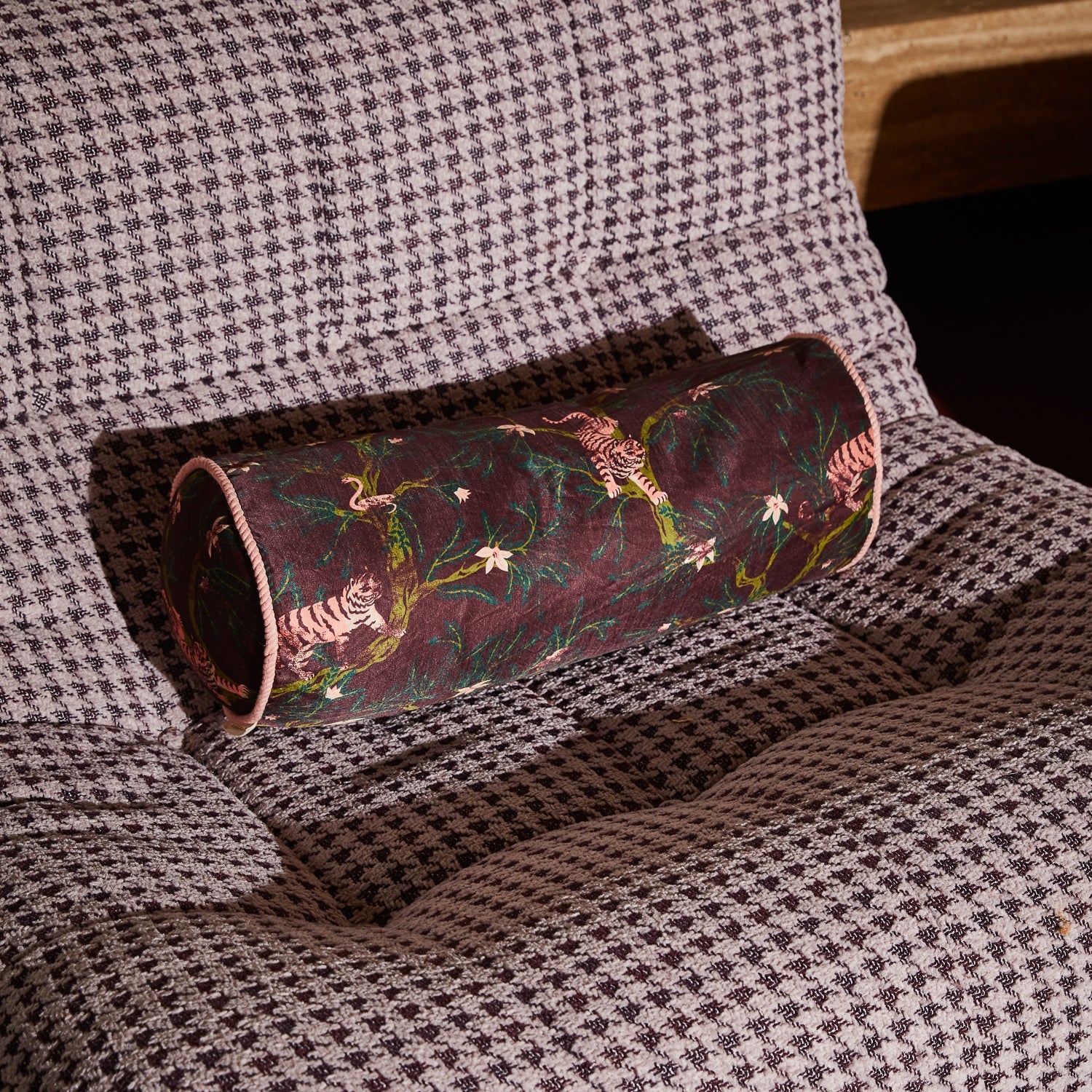 Andrea Bolster Cushion on textured throw showing cylindrical shape and pink piping detail