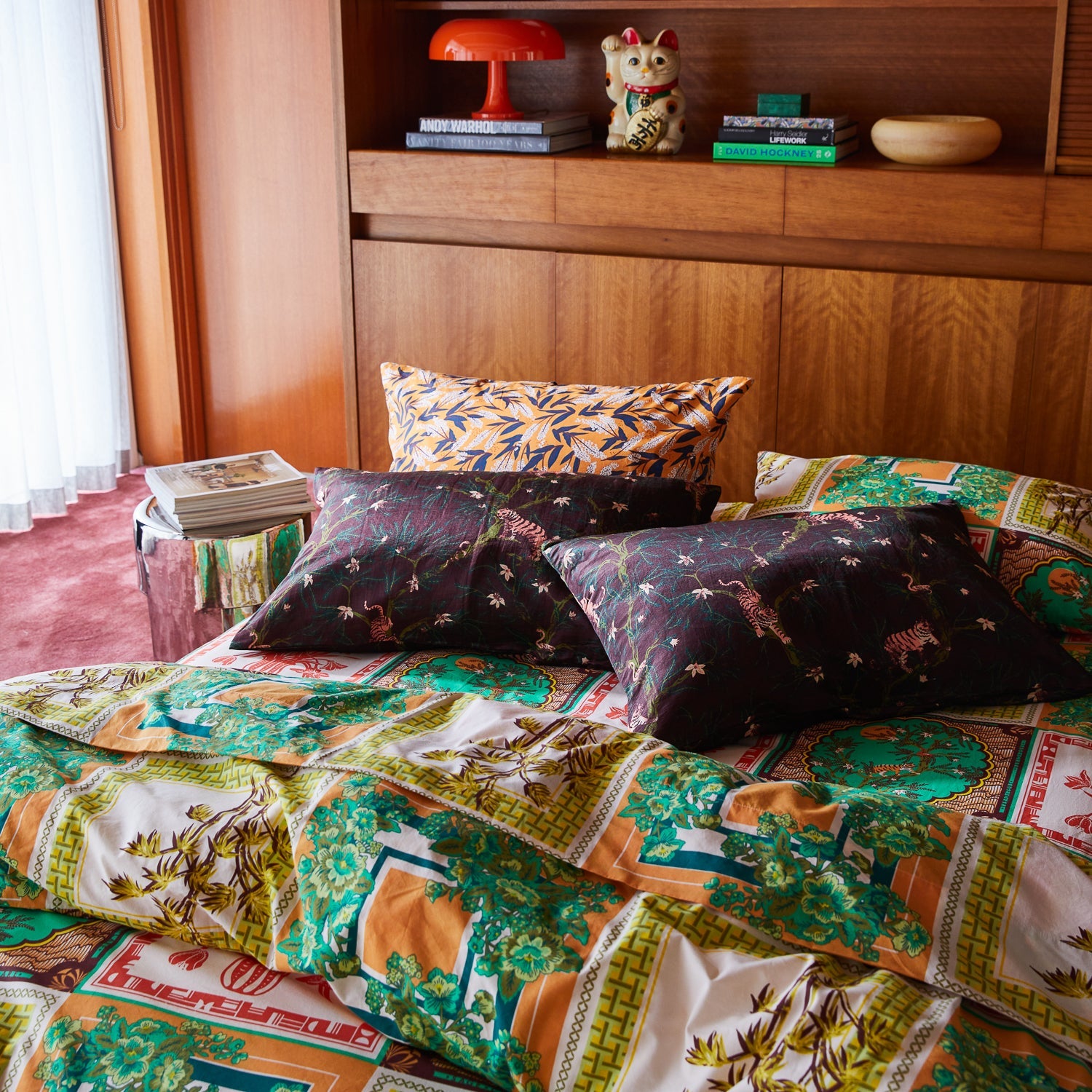 Andrea Rosewood pillowcase on made bed with eclectic maximalist bedding mix and mid-century modern furniture