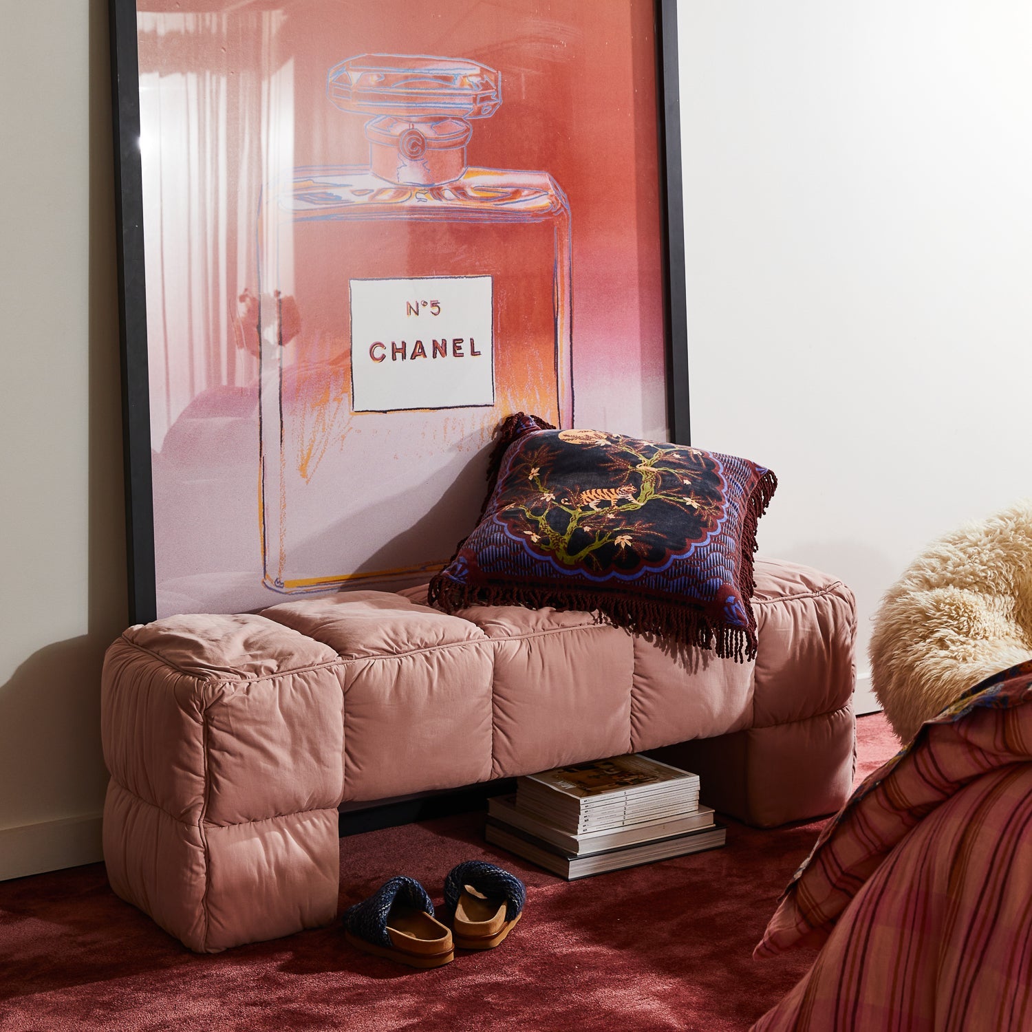 Andrea Velvet Cushion styled on pink tufted bench showcasing jungle print and textured fringe trim