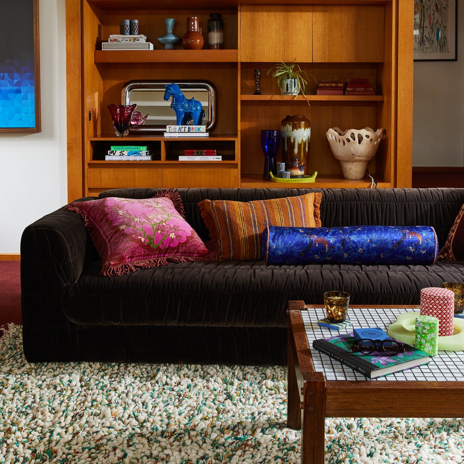 Andrea Velvet Cushion Pansy styled in modern living room with mid-century furniture and shelving