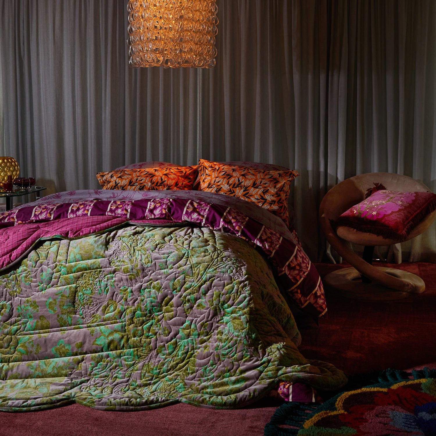 Bedroom styling with Andrea Velvet Cushion Pansy on chair beside bed with colorful bedding