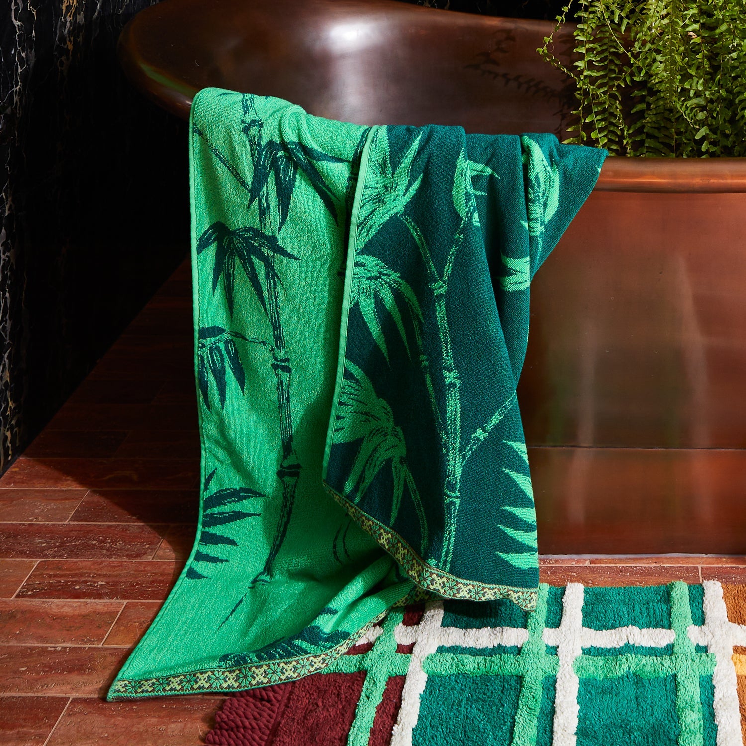 Spring green bath towel with complementary trim detail showing premium terry cotton texture and quality