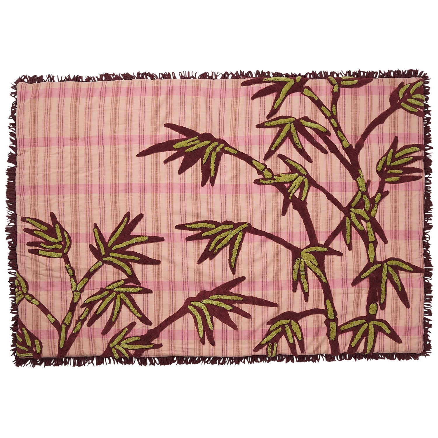 Detail view of burgundy tufted fringe edge and palm leaf embroidery on Aneta blanket corner