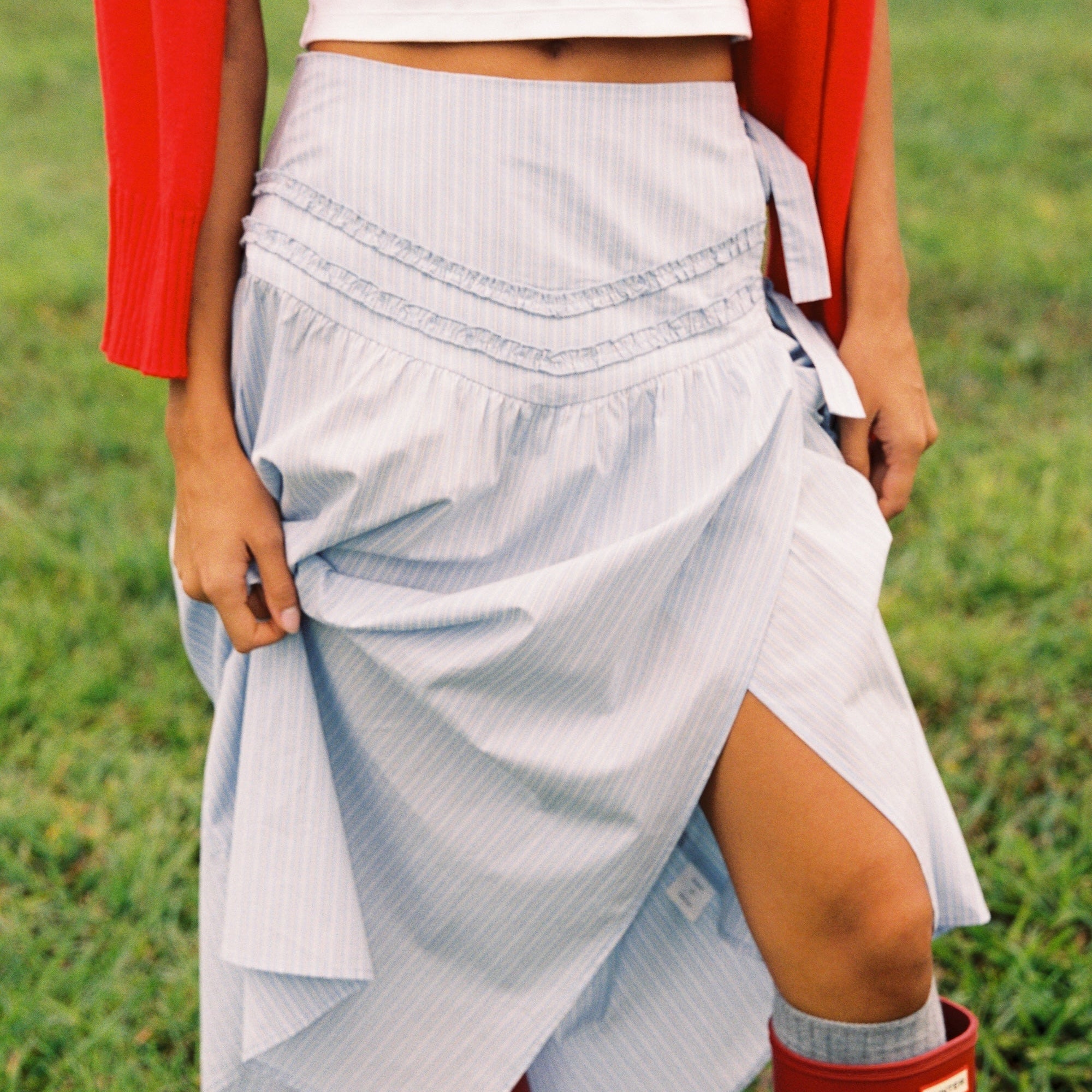 Side view of Annika Midi Skirt showing wrap style and blue striped fabric texture