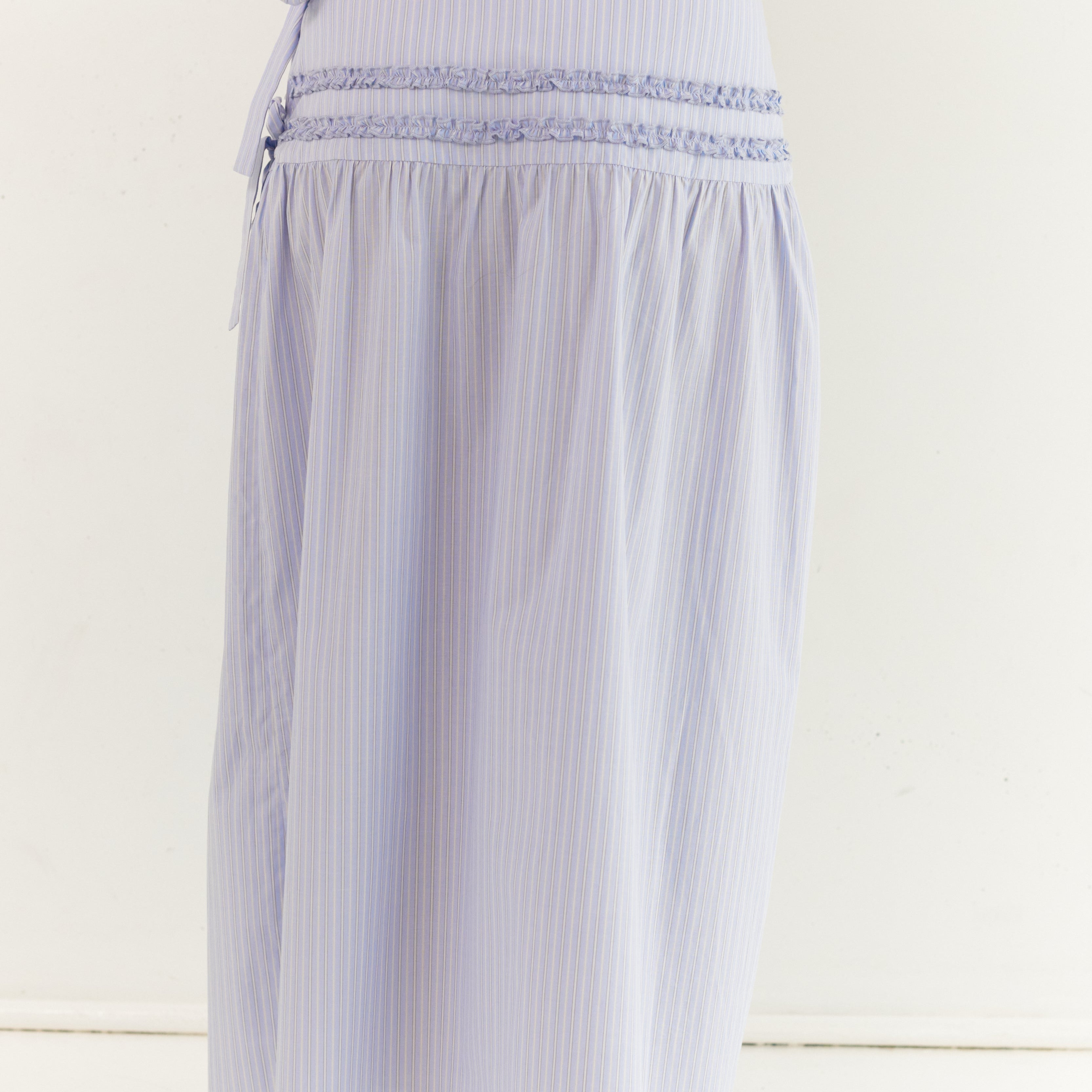 Back view of striped midi skirt showing smocked waistband and A-line shape