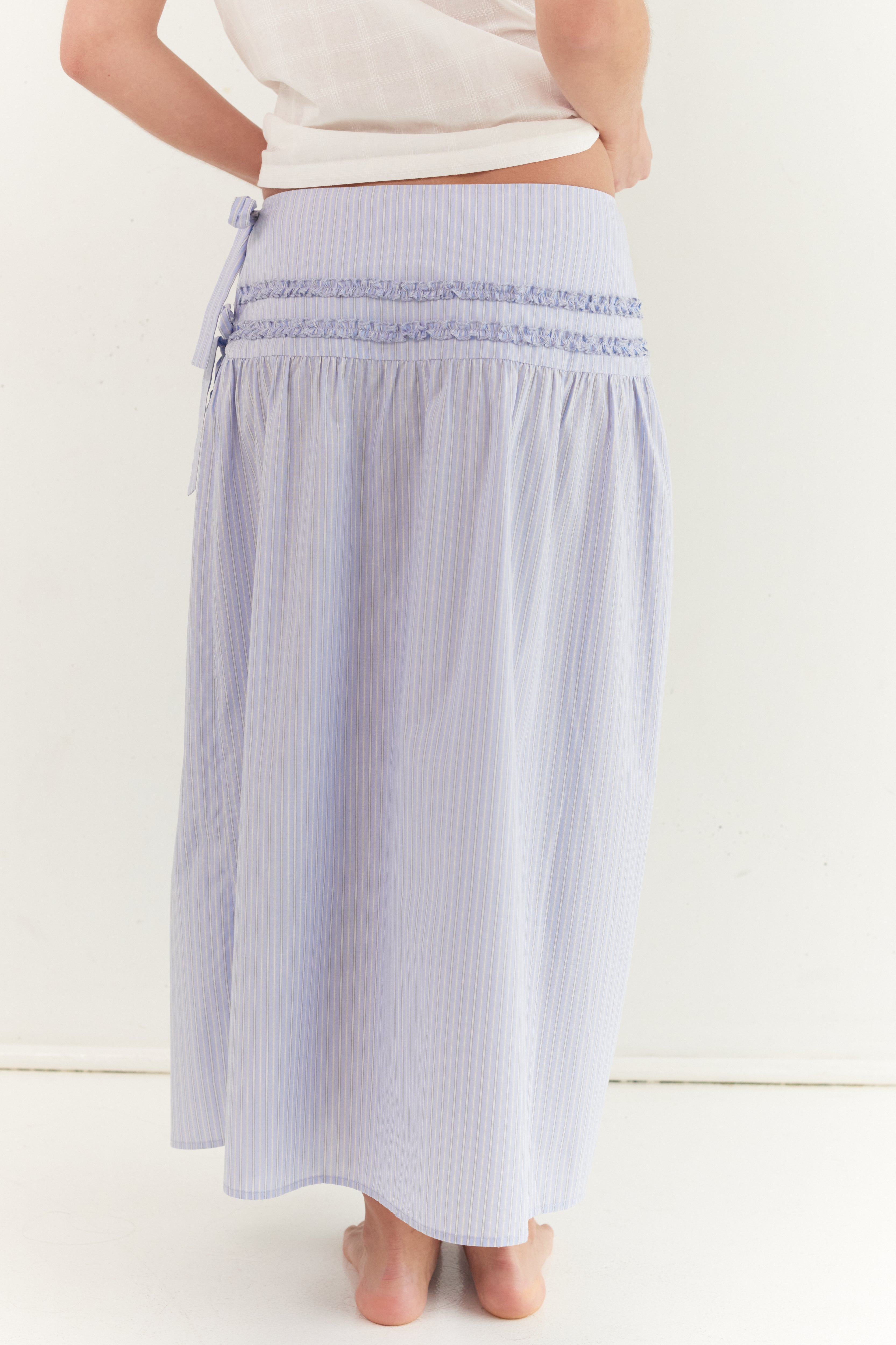 Back view of striped midi skirt showing smocked waistband and A-line shape