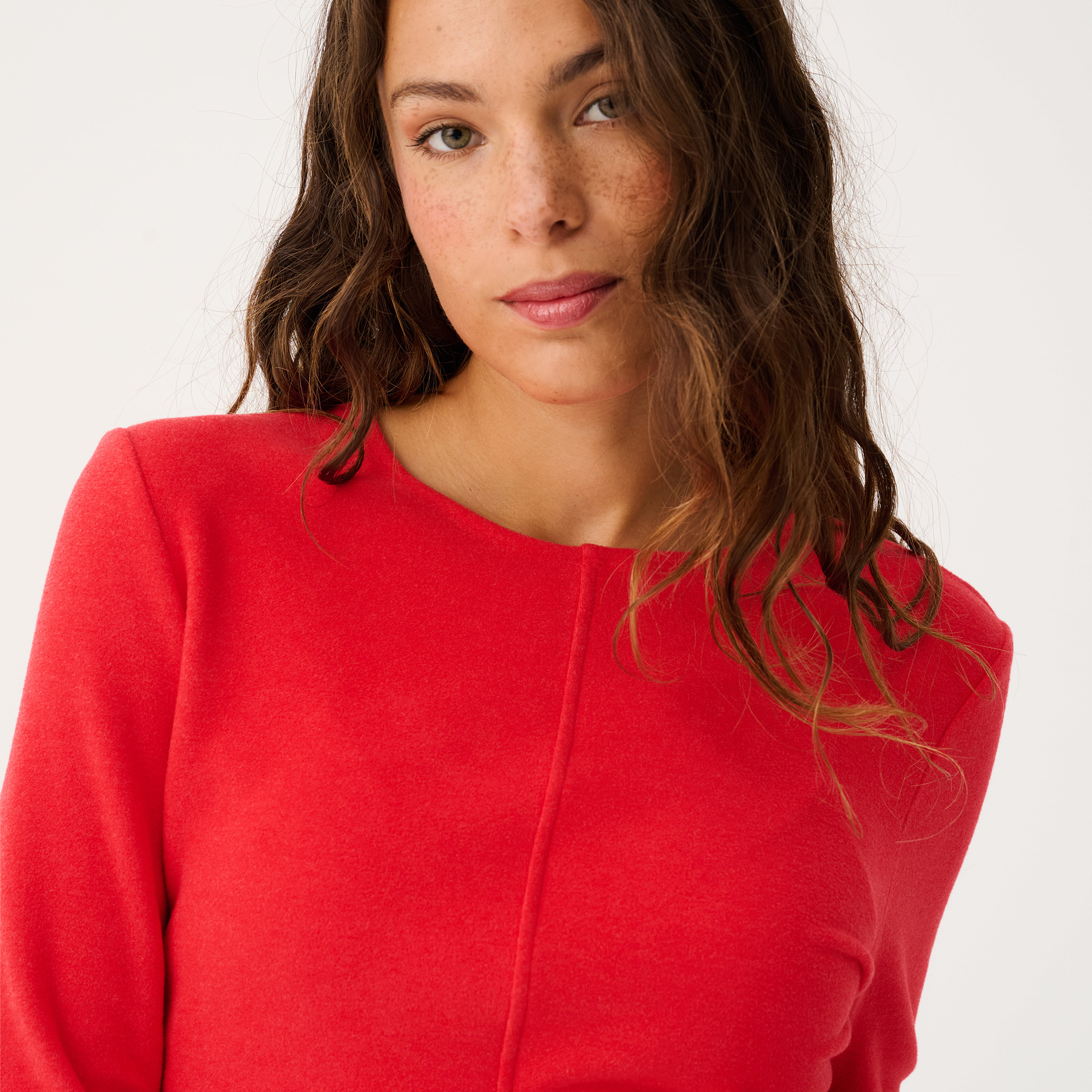 Close-up front view of red Aspyn Top Siren highlighting center seam construction and crew neckline
