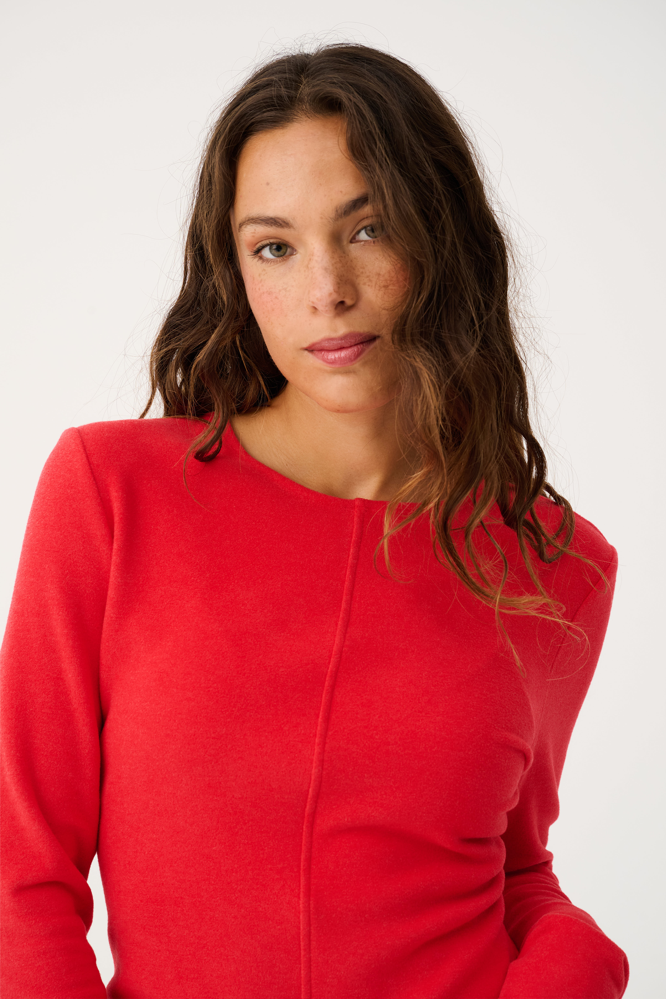 Close-up front view of red Aspyn Top Siren highlighting center seam construction and crew neckline