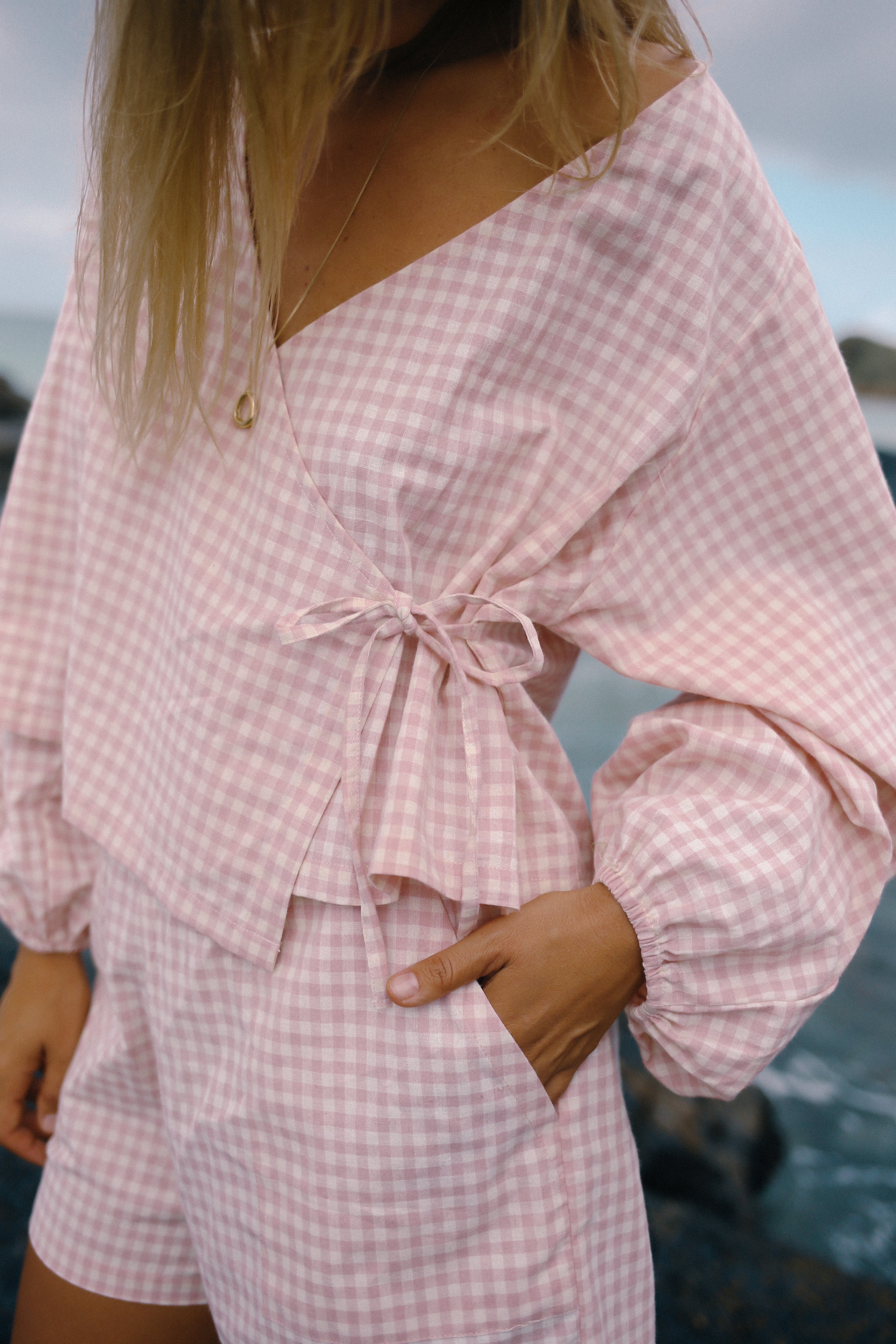 Lady wearing the Ava short pink gingham by the Bare Road