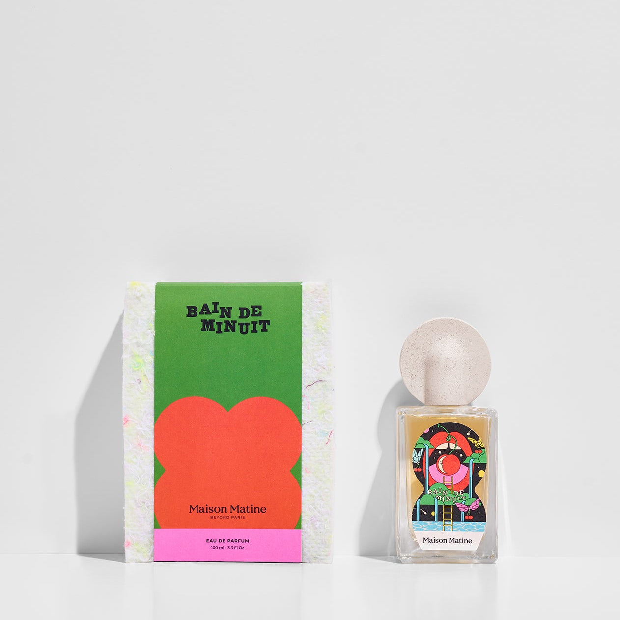 Bain De Minuit eau de parfum with green and pink packaging box displayed together on white surface
