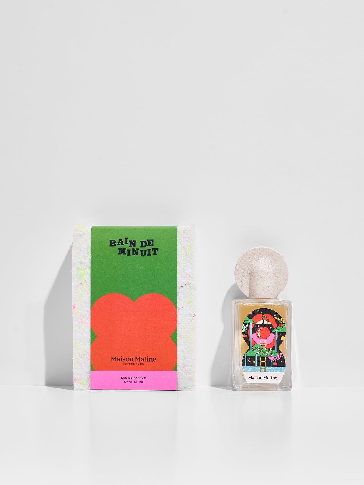 Bain De Minuit eau de parfum with green and pink packaging box displayed together on white surface
