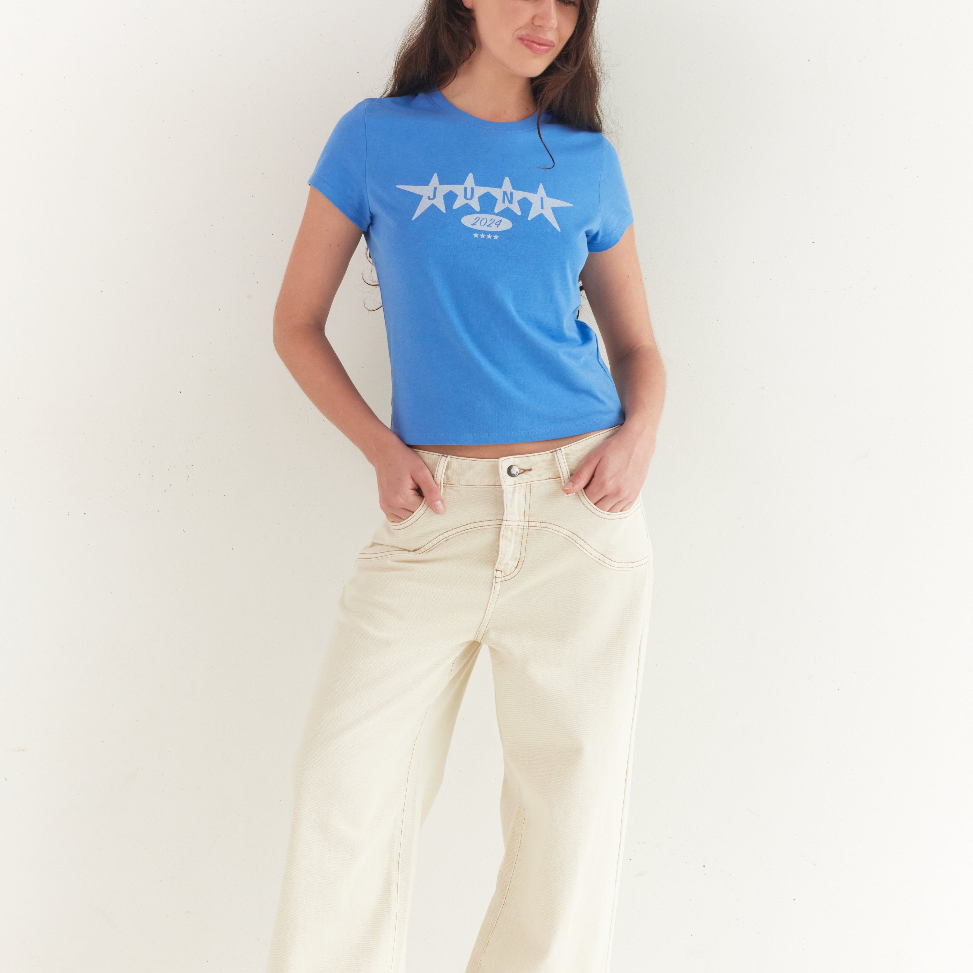 Full body shot of azure blue Star Baby Tee with white star design and short sleeves