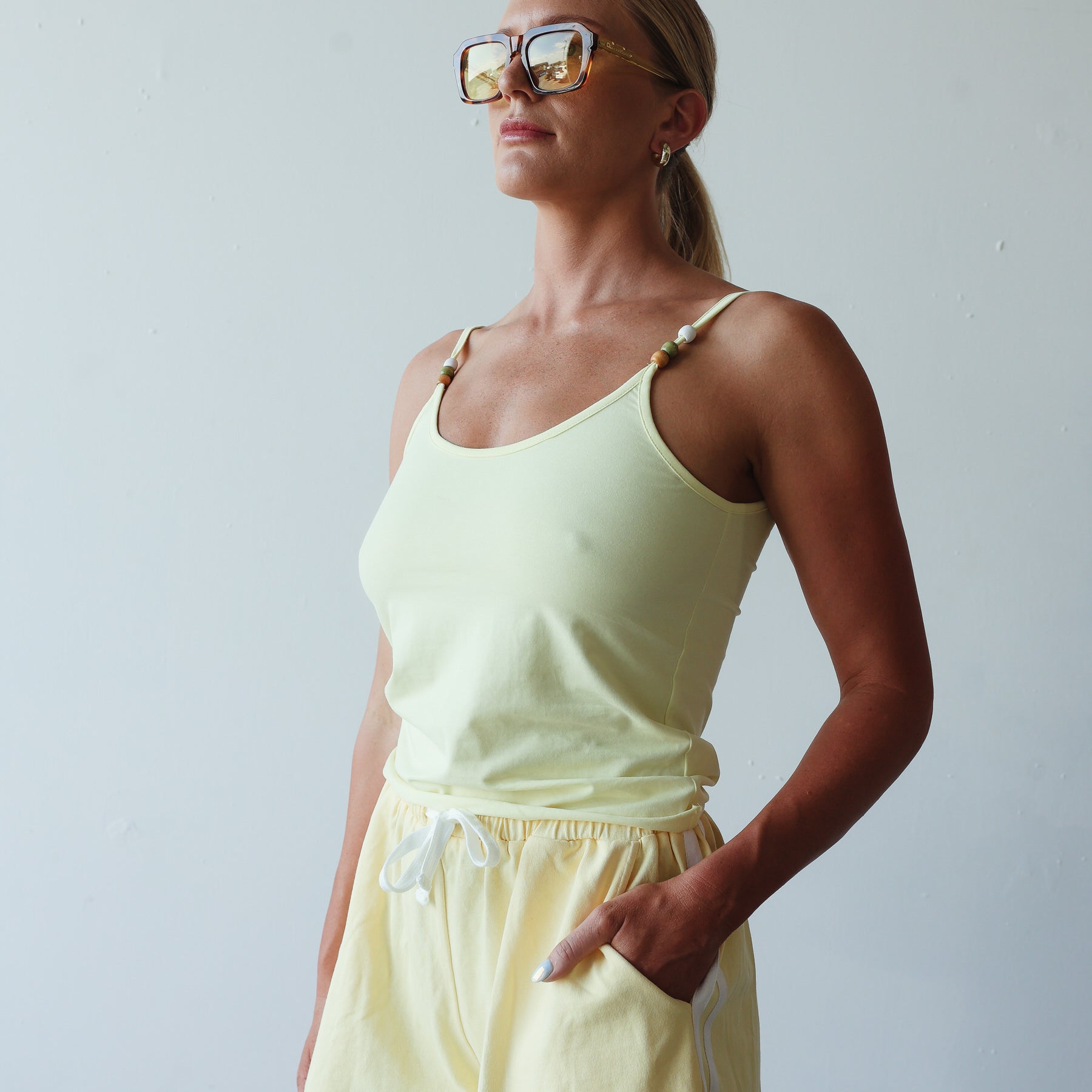 light yellow womens singlet with beads on the straps
