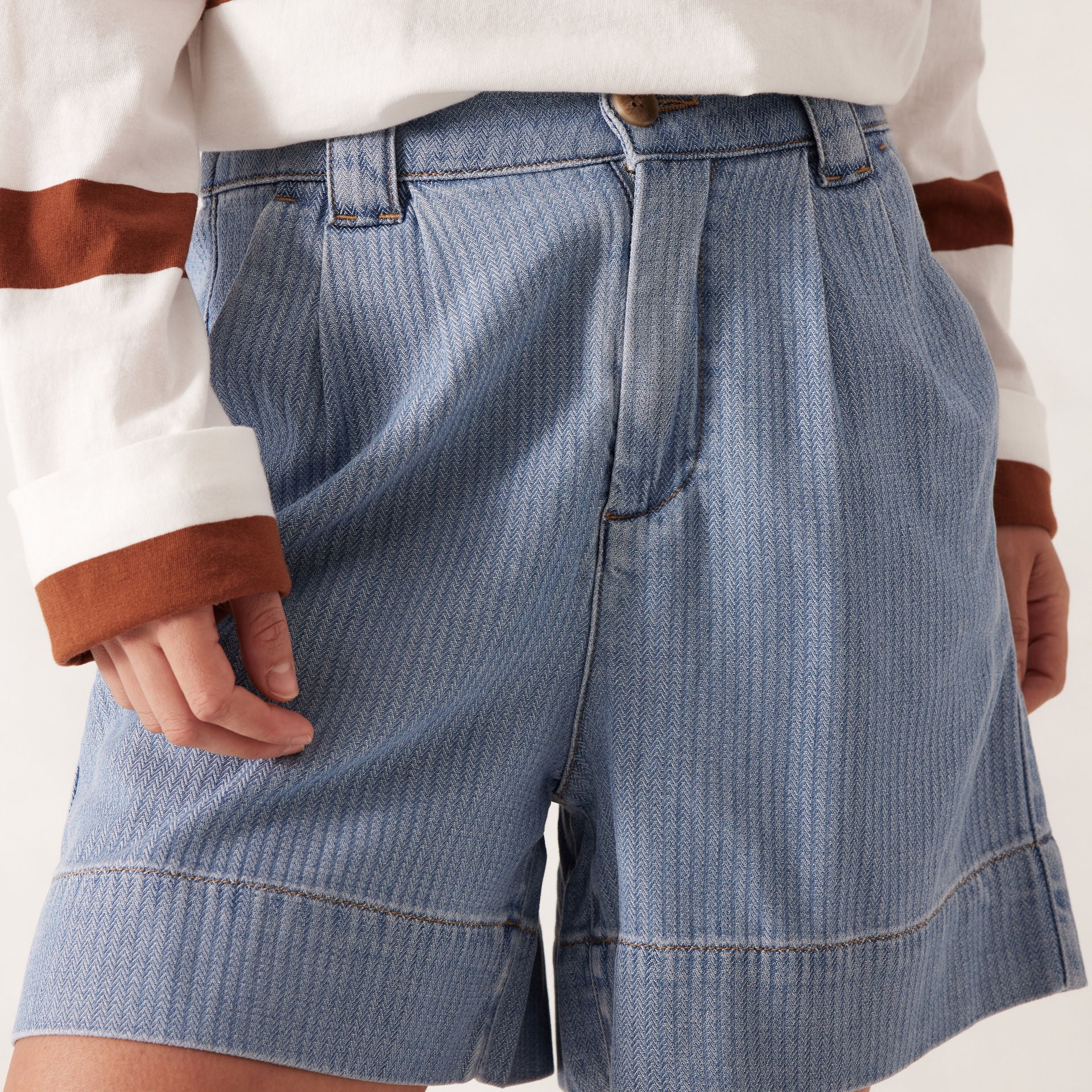 model wearing Billie Pleat Front Short by Ceres Life - light blue herringbone pattern denim shorts