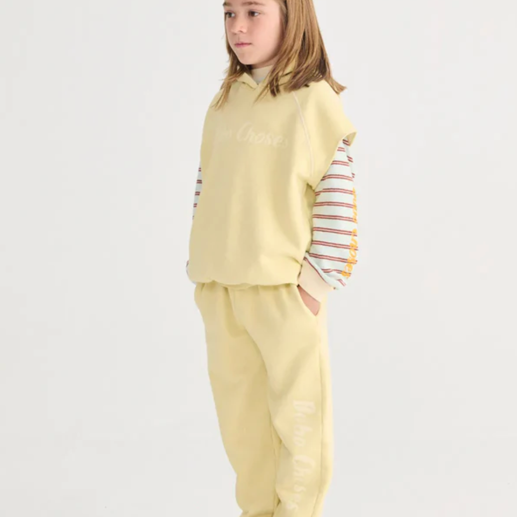 Side view of girl wearing Bobo Choses Sleeveless Hoodie - Yellow | Bobo Choses