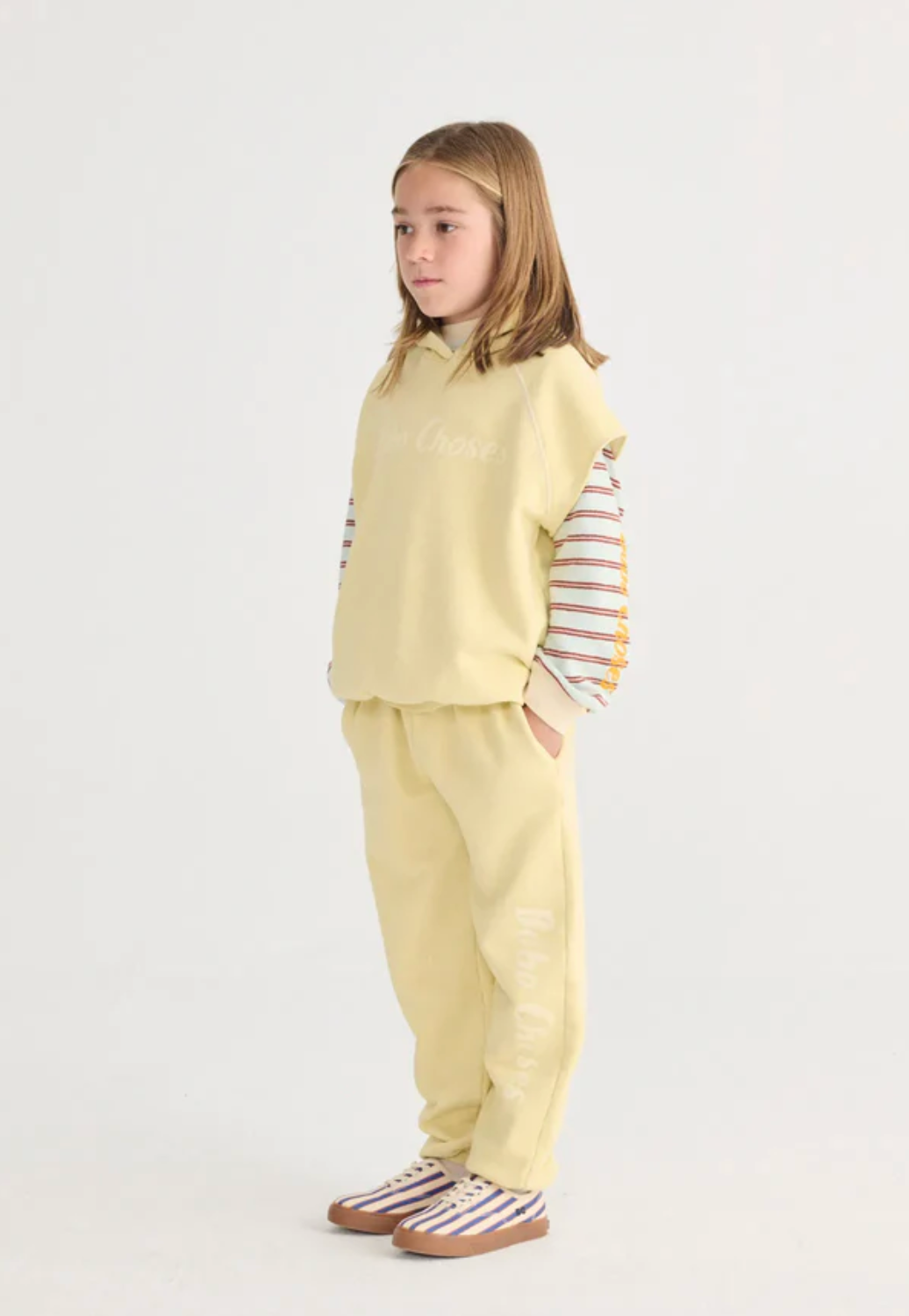 Side view of girl wearing Bobo Choses Sleeveless Hoodie - Yellow | Bobo Choses