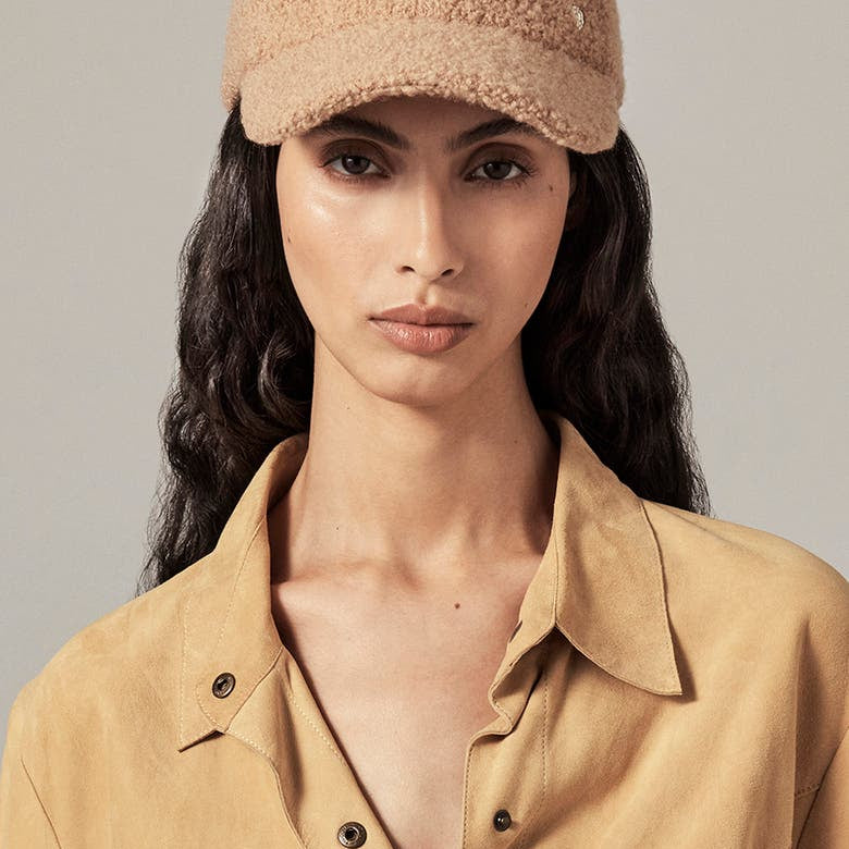 model wearing tan wool cap by Helen Kaminski