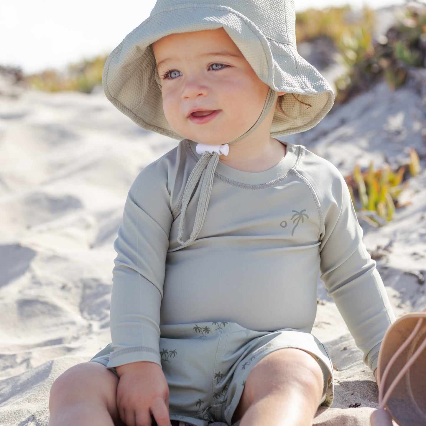 Front view of young boy wearing the Boys Swim Short Palm | Quincy Mae