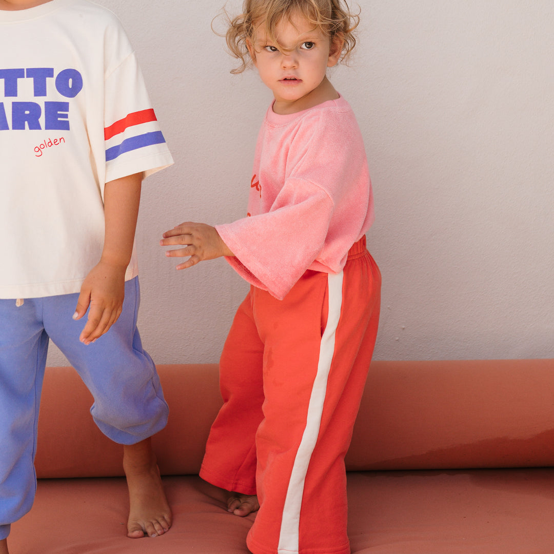 Side view of girl wearing the Buon Appetito T-shirt - Pink Icing | Golden Children