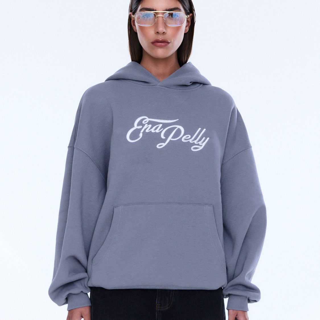 Front view of gray Cassie Oversized Hoodie with white logo and kangaroo pocket detail