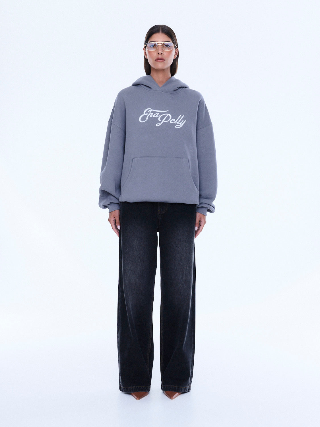 Front view of gray Cassie Oversized Hoodie with white script logo and hood styling
