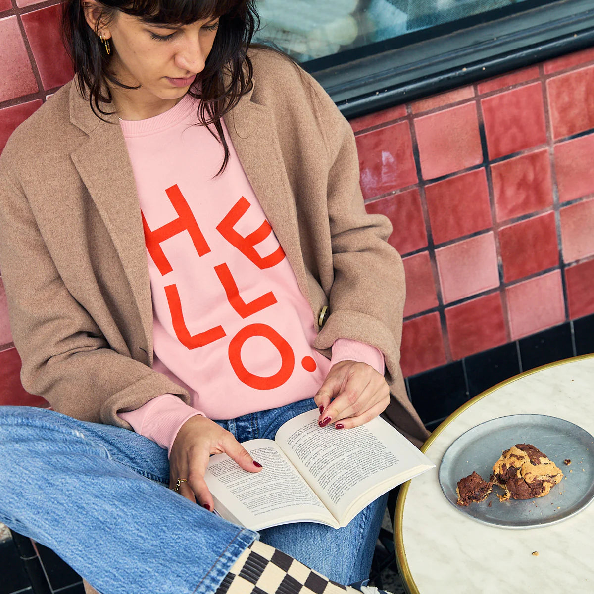 Pink sweater with read text reading HELLO