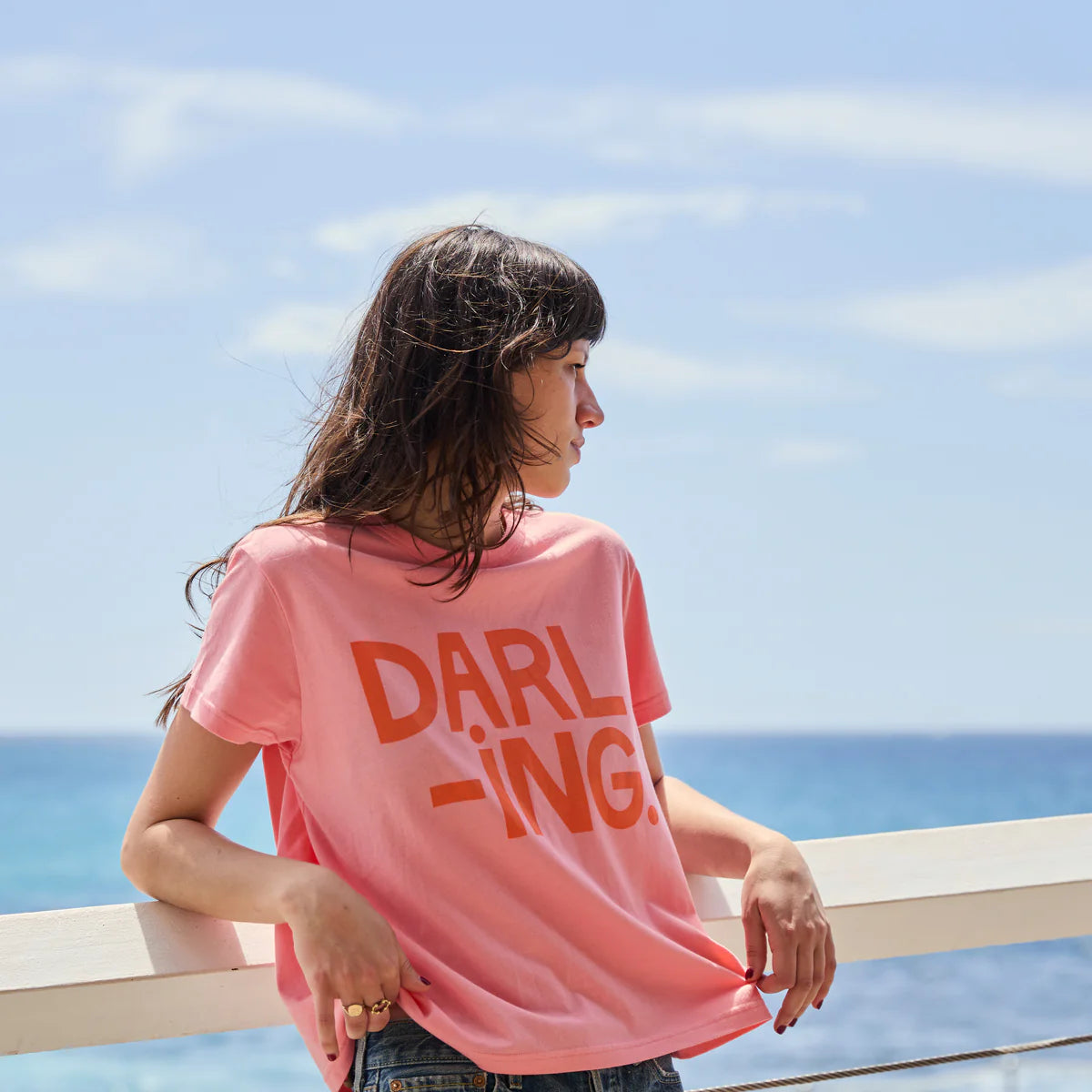 Pink t-shirt with red writing saying Darling by Castle