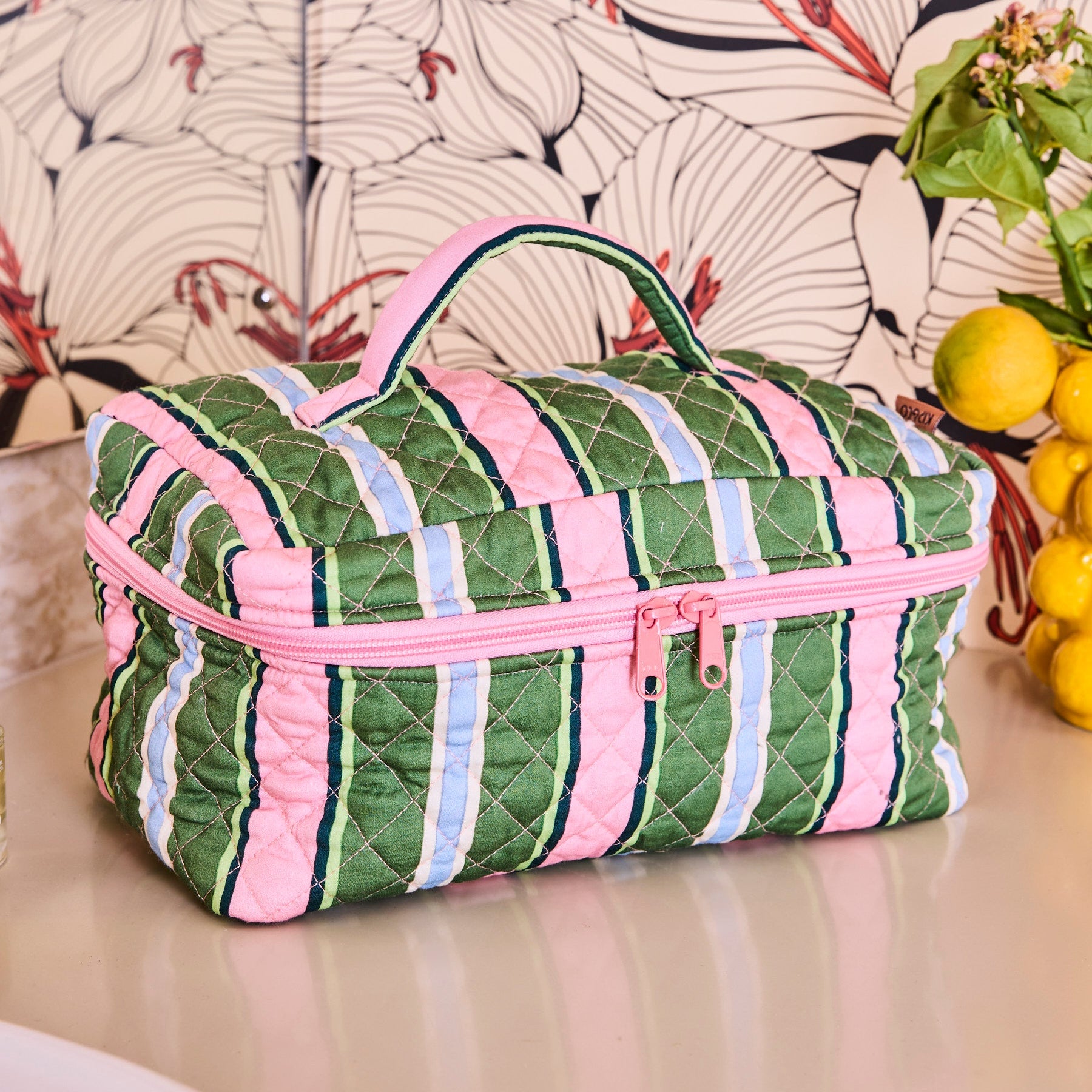 Kip & Co Cactus Stripe Quilted Cotton Toiletry Case front view with pink green blue striped pattern and pink zipper