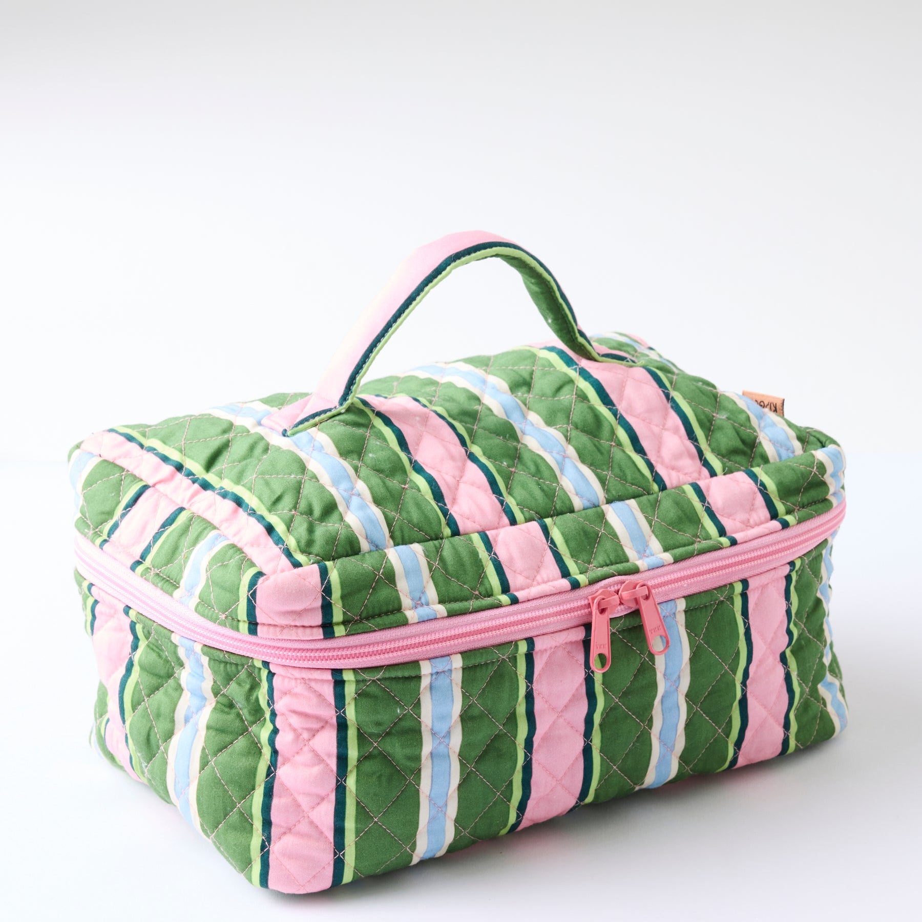 Side angle of Kip & Co Cactus Stripe Quilted Cotton Toiletry Case displaying diamond quilted texture and handle