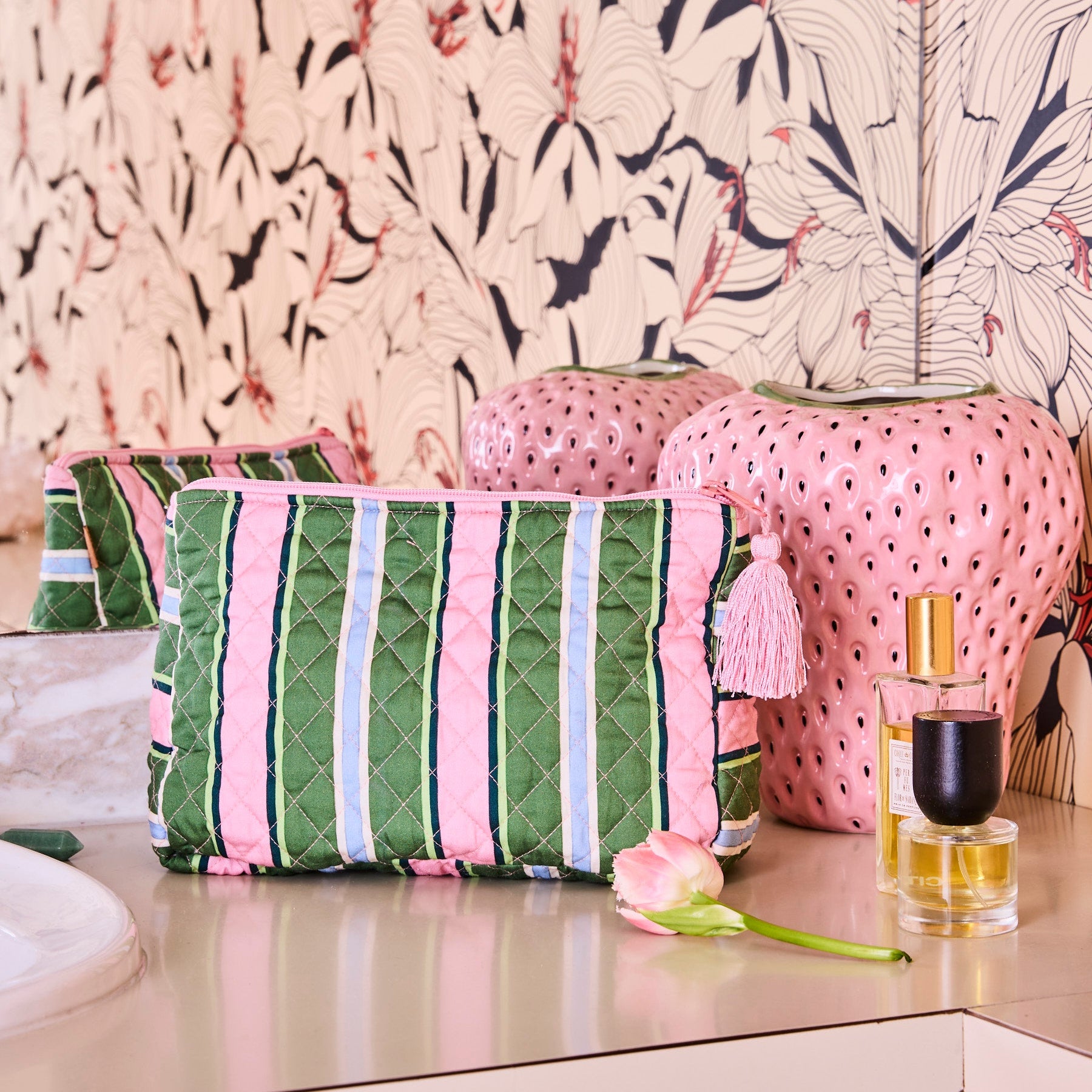 Cactus Stripe Quilted Cotton Toiletry Purse styled on vanity with pink striped cosmetic bag and beauty products