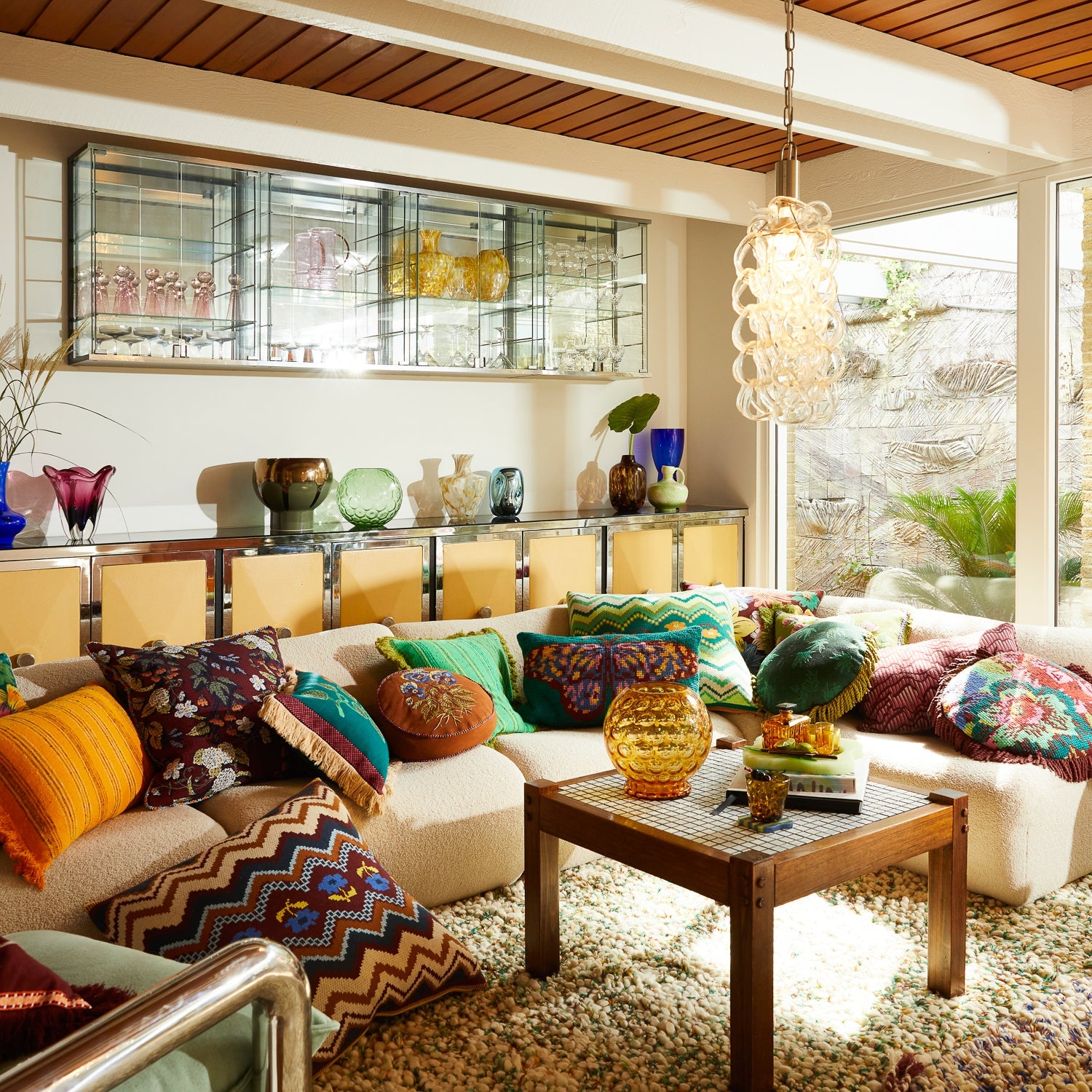 Interior design scene featuring Calina Verdant cushion with zigzag motifs among eclectic pillow collection