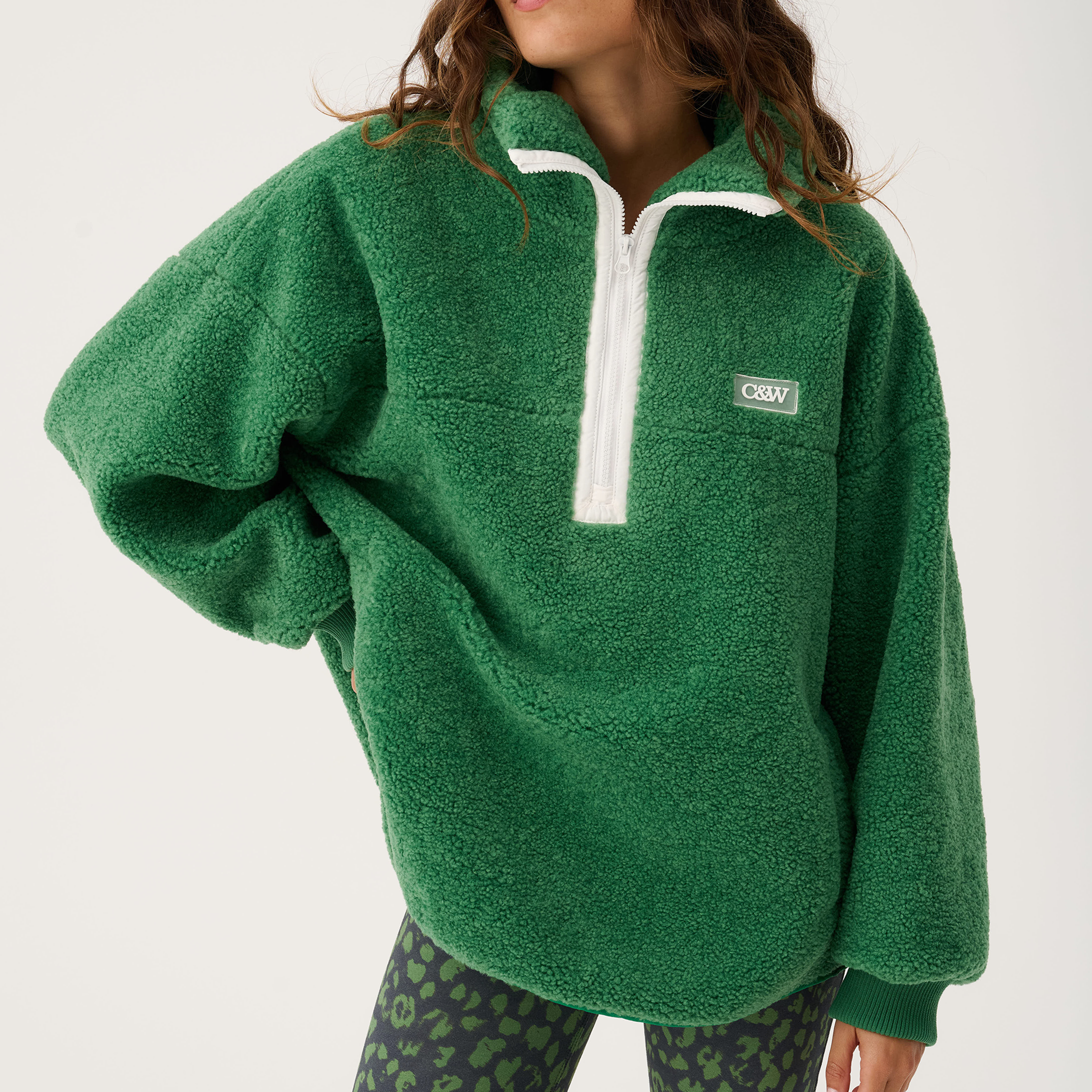 Front view of Celeste Pullover in tide green showing oversized fit and white quarter zip closure