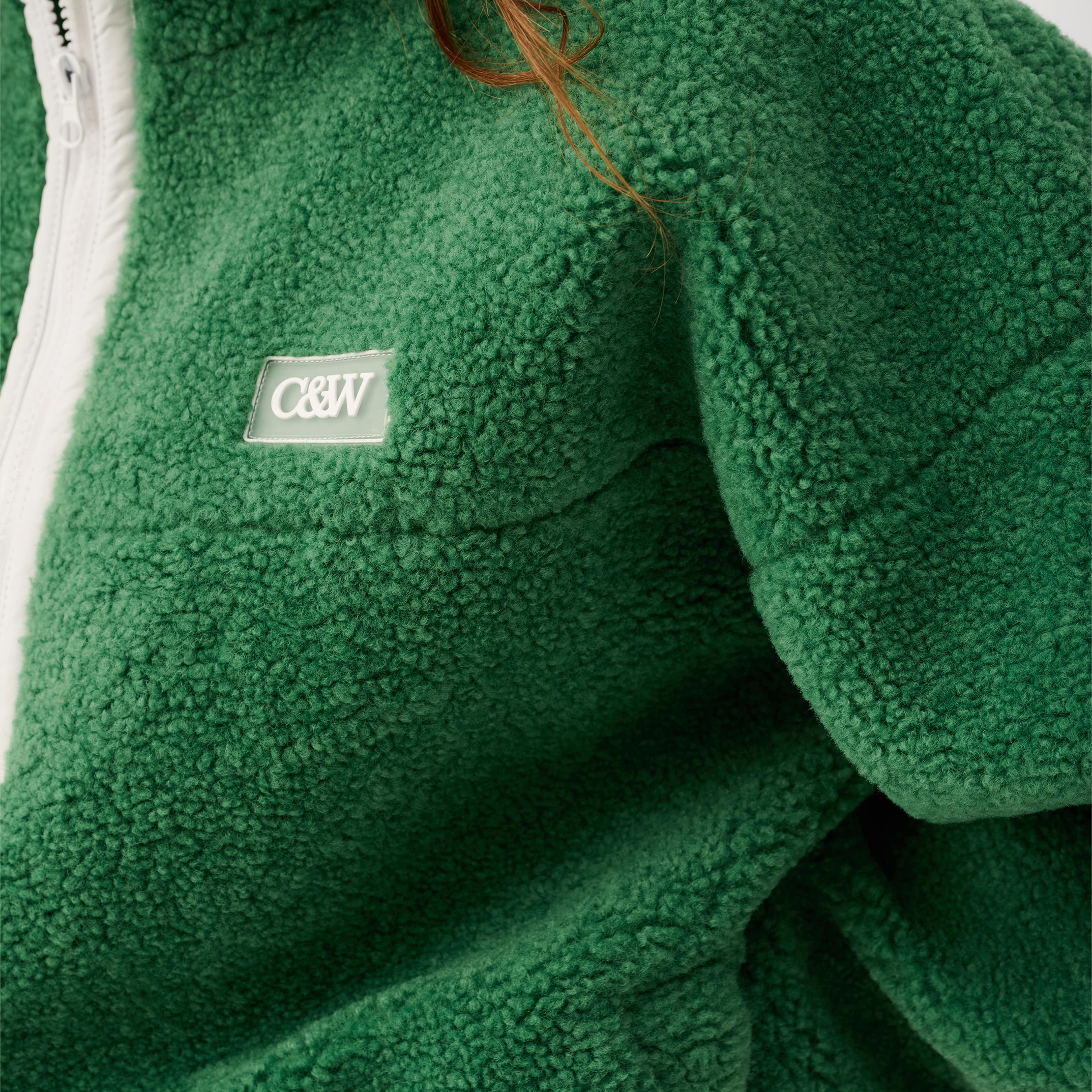 Close-up detail of Celeste Pullover showing textured fleece fabric and brand patch