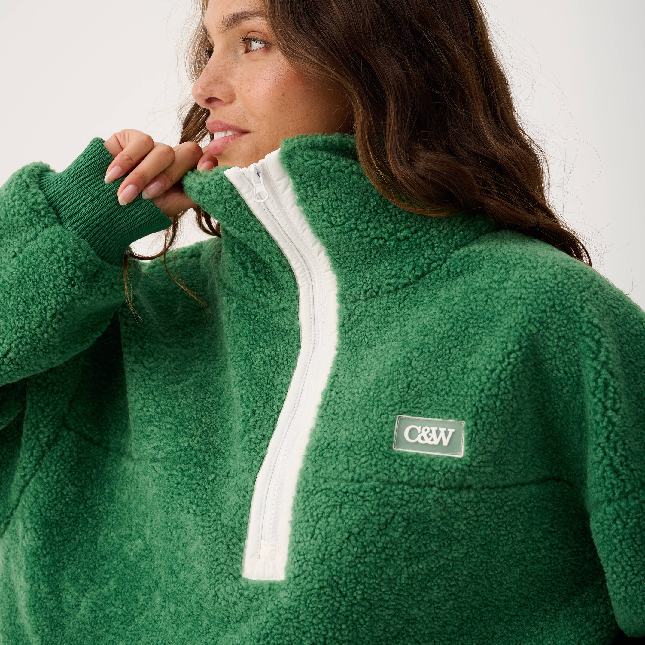 Side angle of Celeste Pullover showing quarter zip detail and ribbed cuff construction