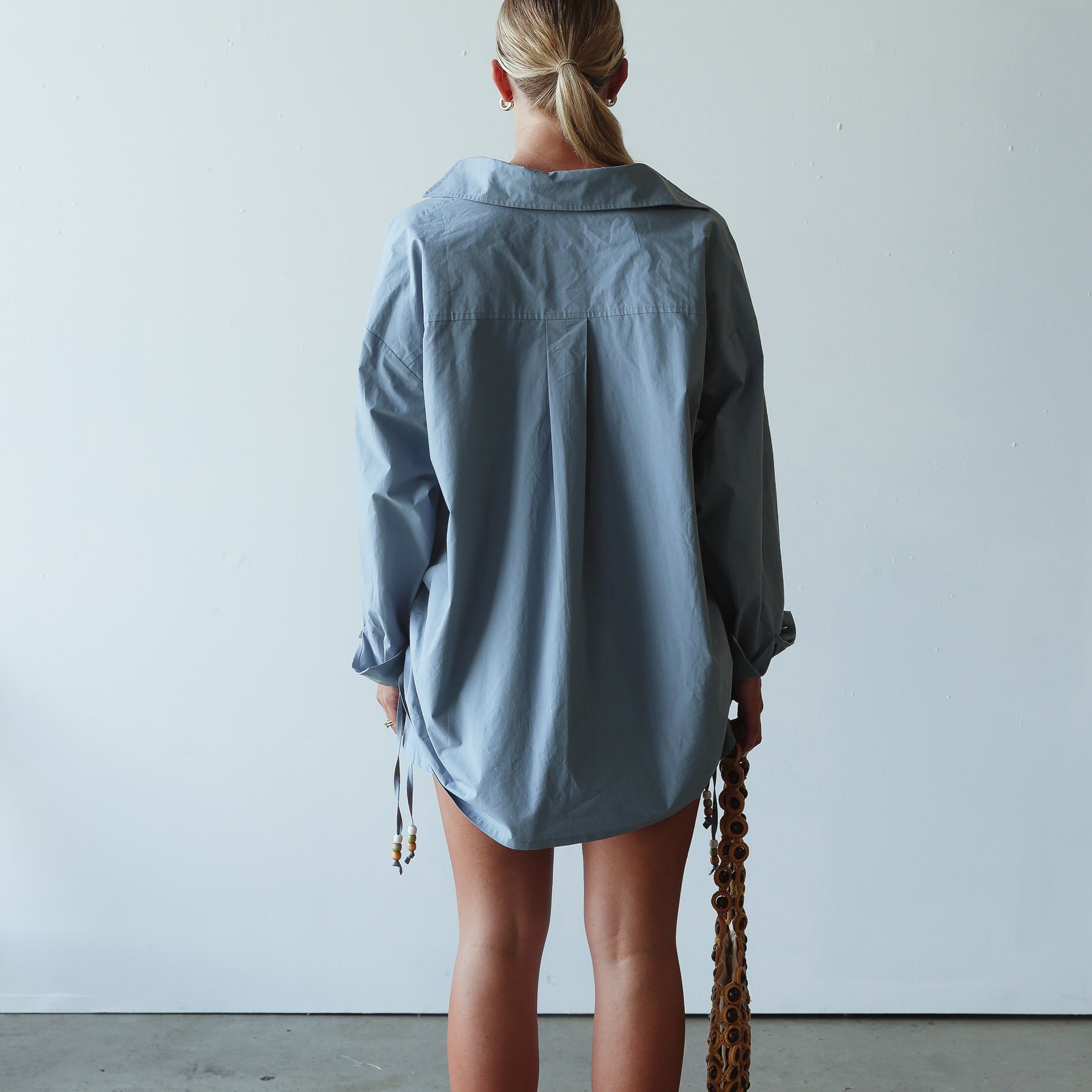 back view of model wearing Celine Shirt - cornflower by By Billie