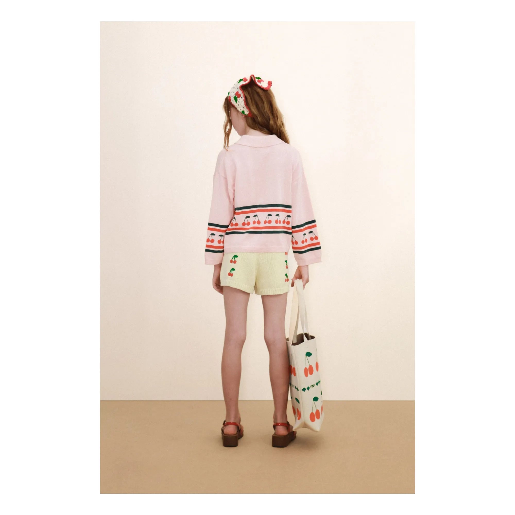 girl wearing pink Cherries Sweater by Tiny Cottons