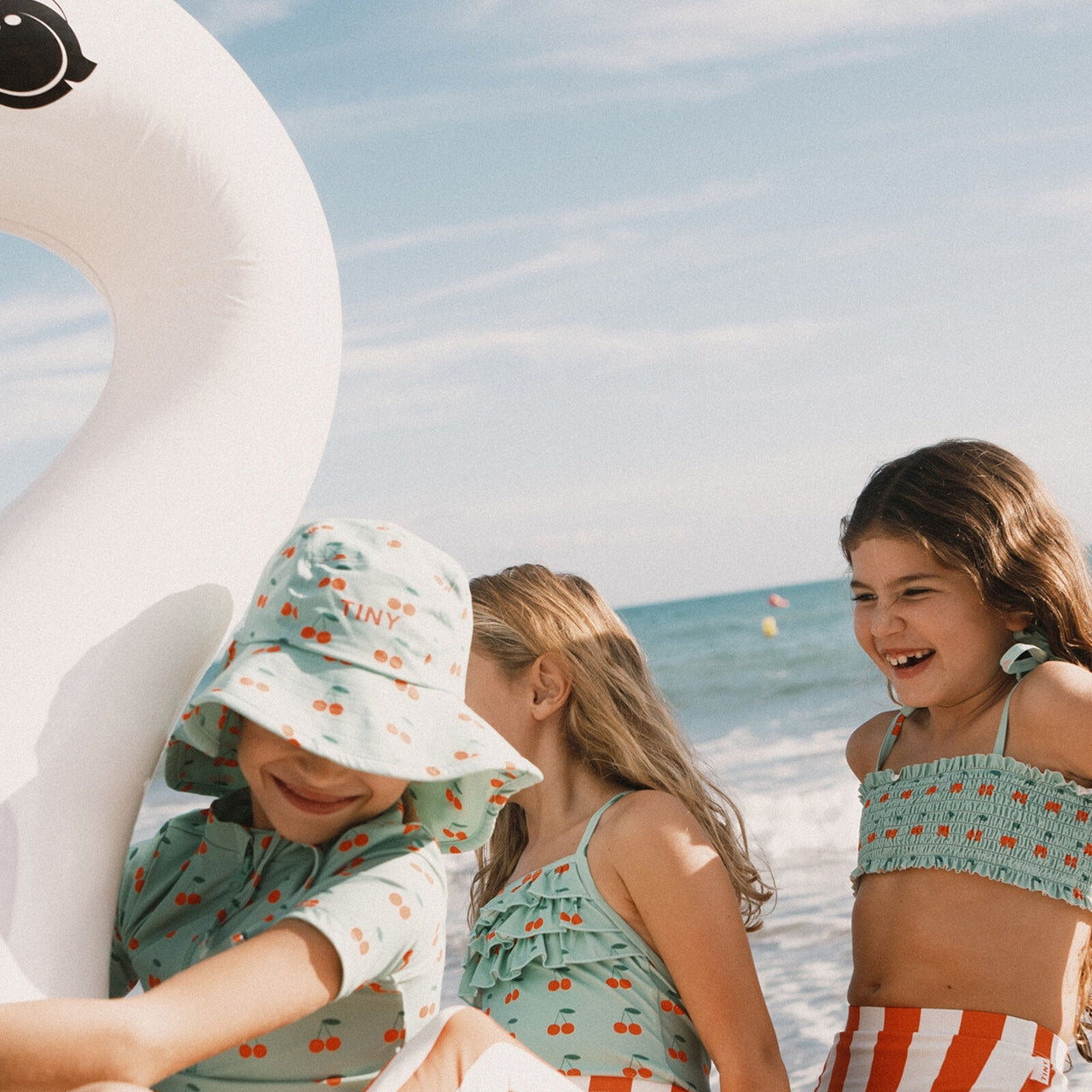 Young girl in the Cherries Smock Swim Set | Tiny Cottons top