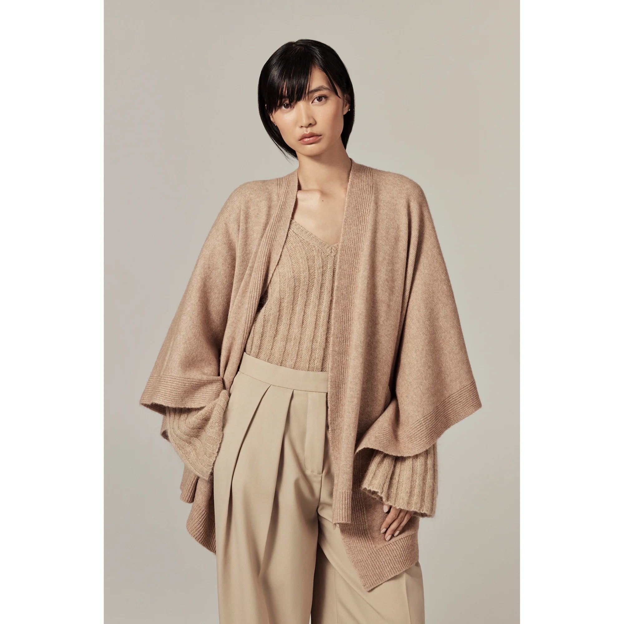 Model wearing tan Clara Wool Blend Poncho by Helen Kaminski