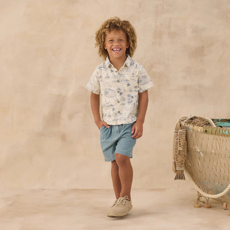 Boy wearing cream collared shirt with blue ocean print