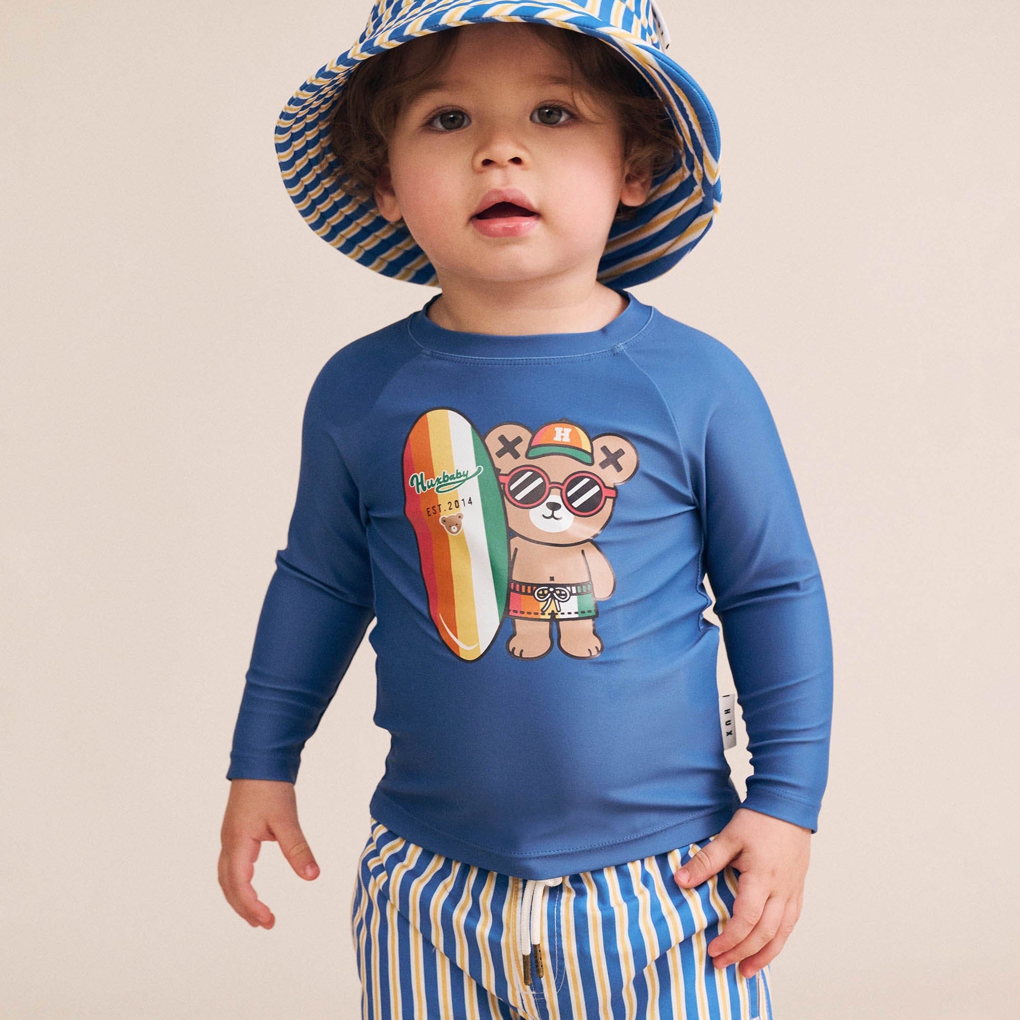 Boy wearing the Collegiate Stripe Boardshort | Huxbaby