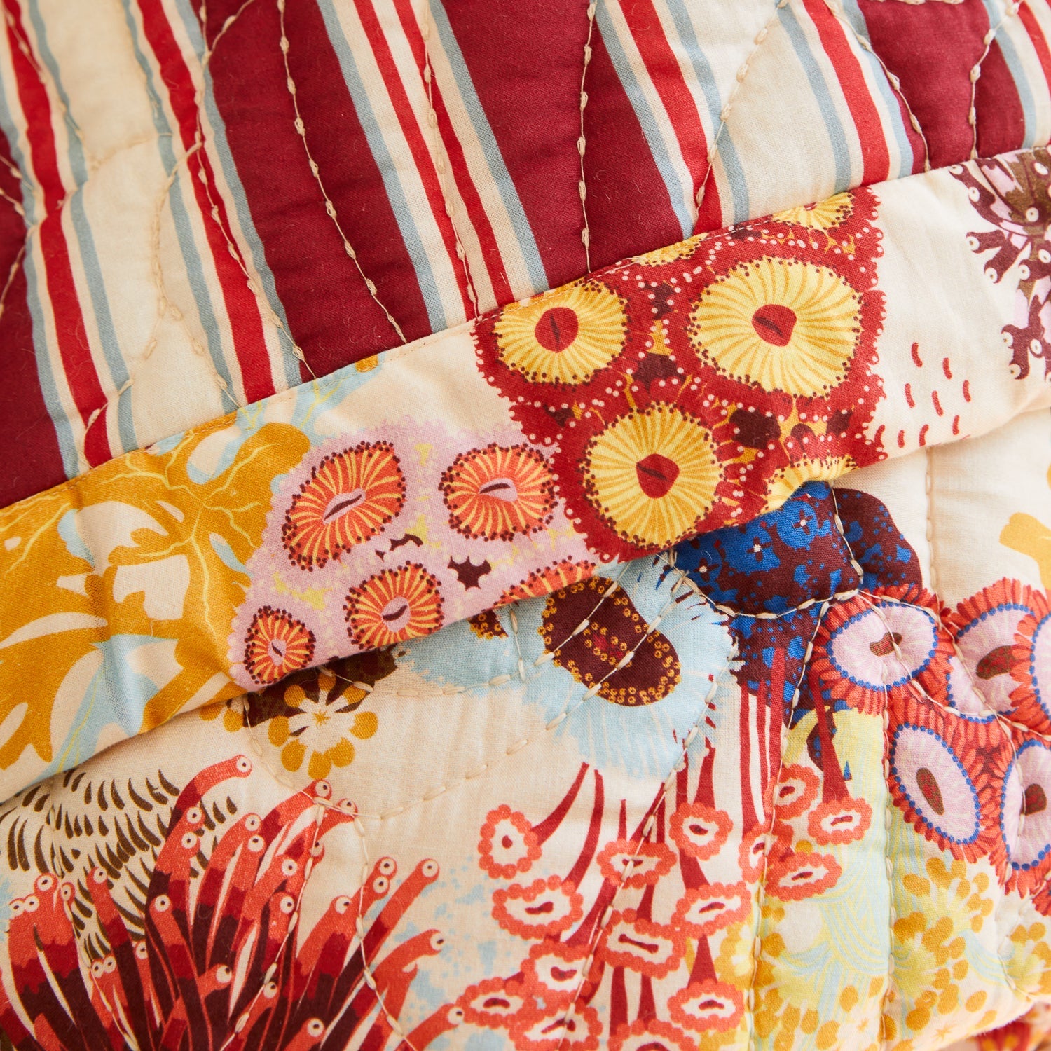 Cozy bedroom styling with pearl bedcover layered over white bedding