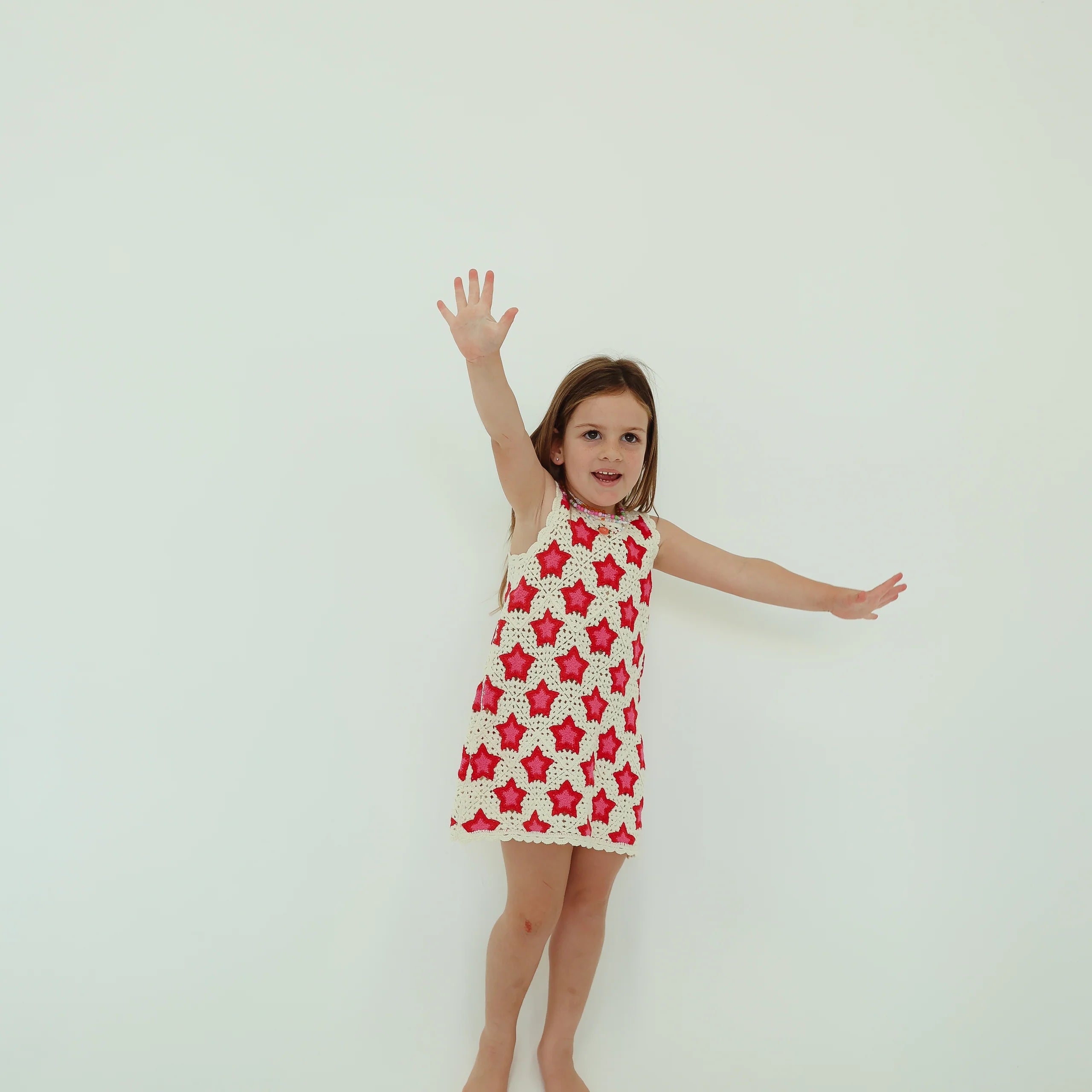 girl wearing dress by BY Billie with pink and red stars
