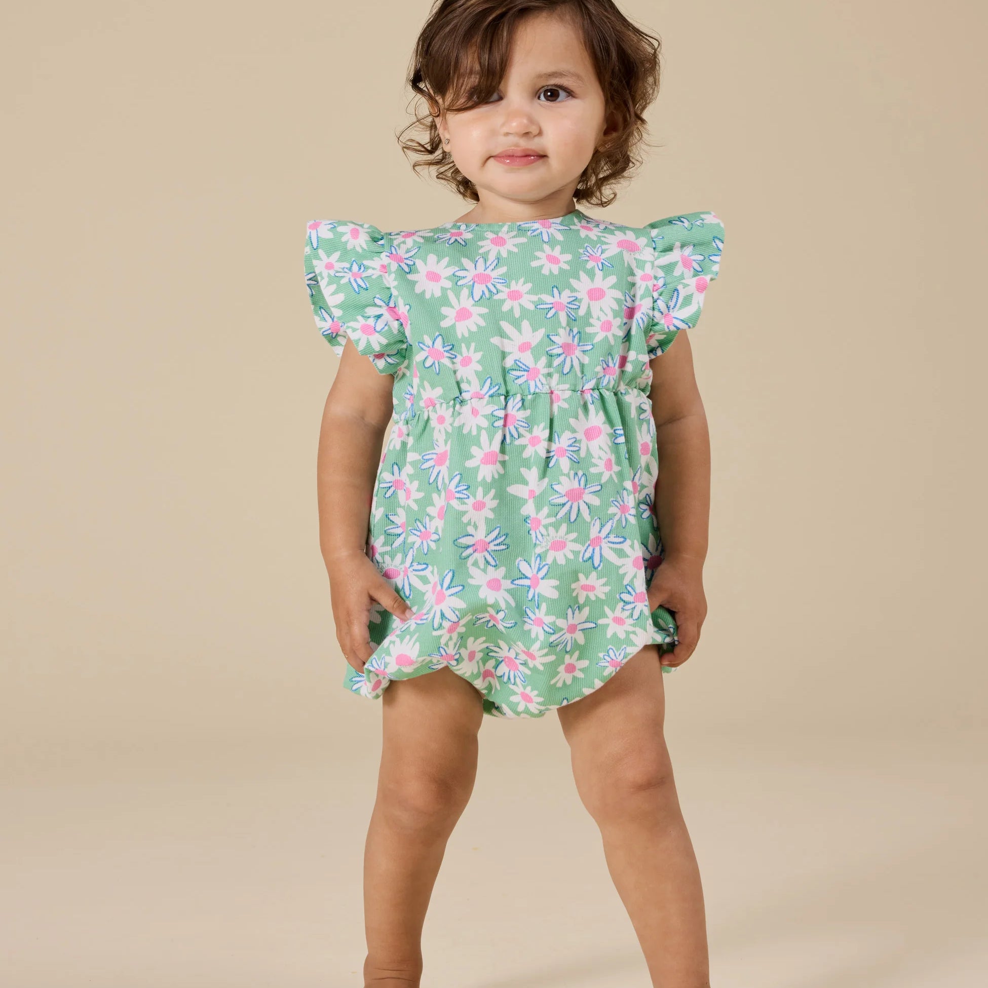 Green romper with pink and white daisies